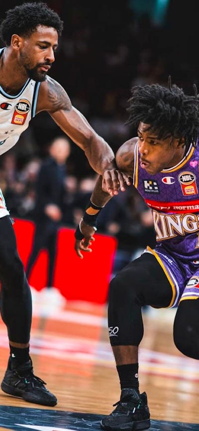 Sydney Kings player and opponent on court