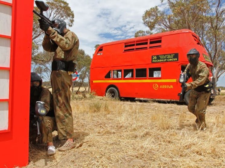 Three men in a game of paintball