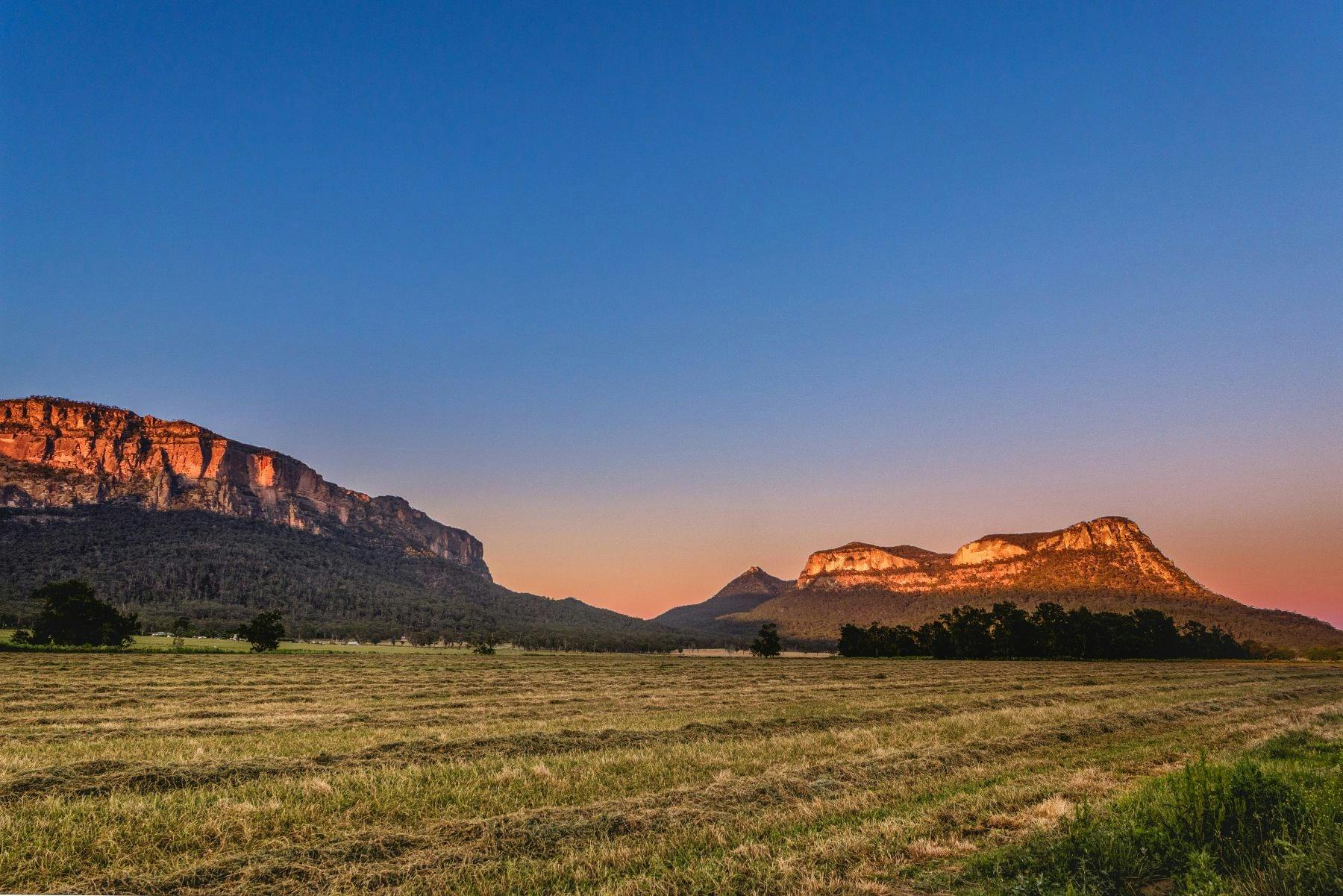 Capertee Valley showing the escarpment and farmland below at sunset