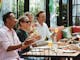 Friends enjoying a summer meal with drinks at The Yard