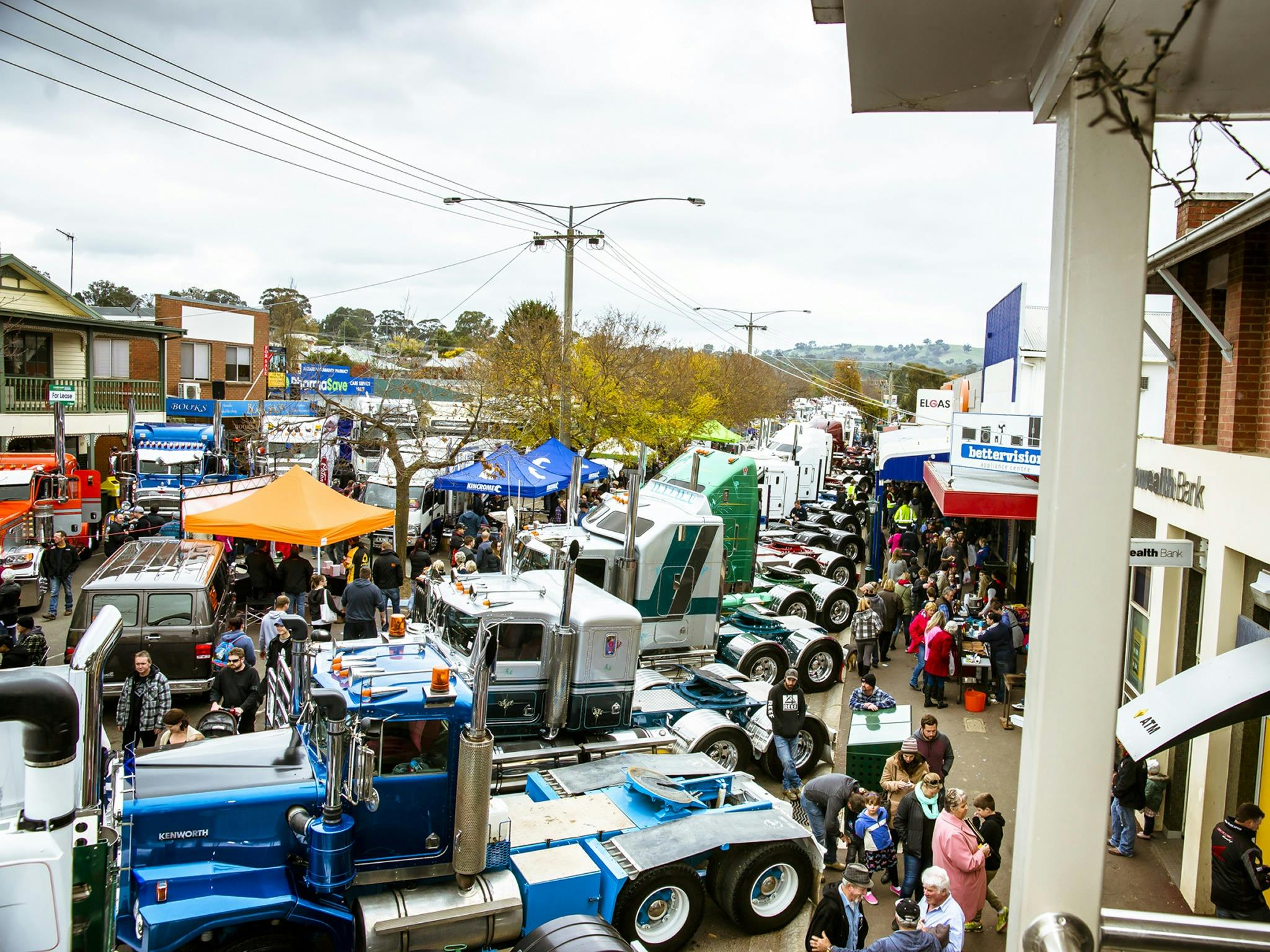 Photo of trucks parked closely together in the main street, taken from a shop balcony
