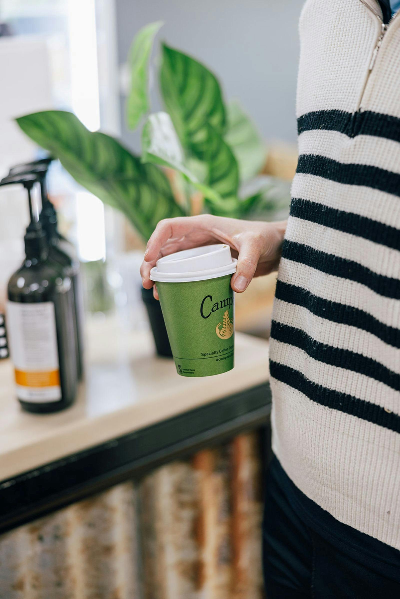 Customer holding a take-away coffee