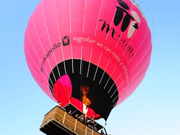 Giant Pink Hot Air Balloon rising up into the Air