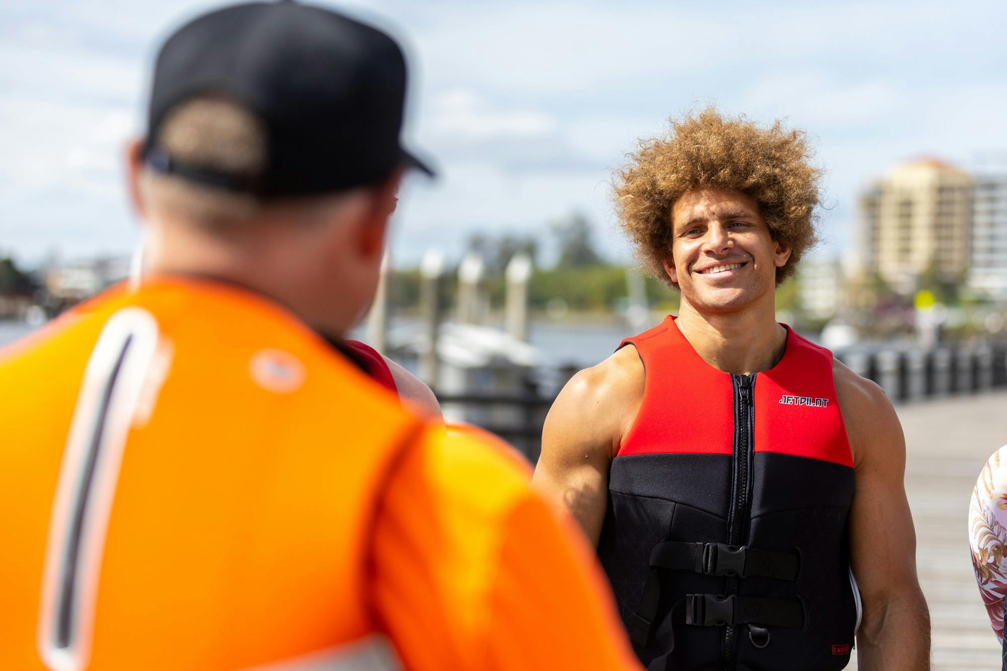 Jetski instructor giving a safety briefing to Eloni Vunakece.