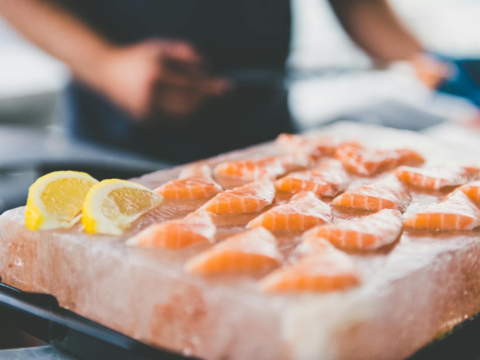 Our chef serves fresh Atlantic salmon sashimi style on a pink slab of rock salt with lemon