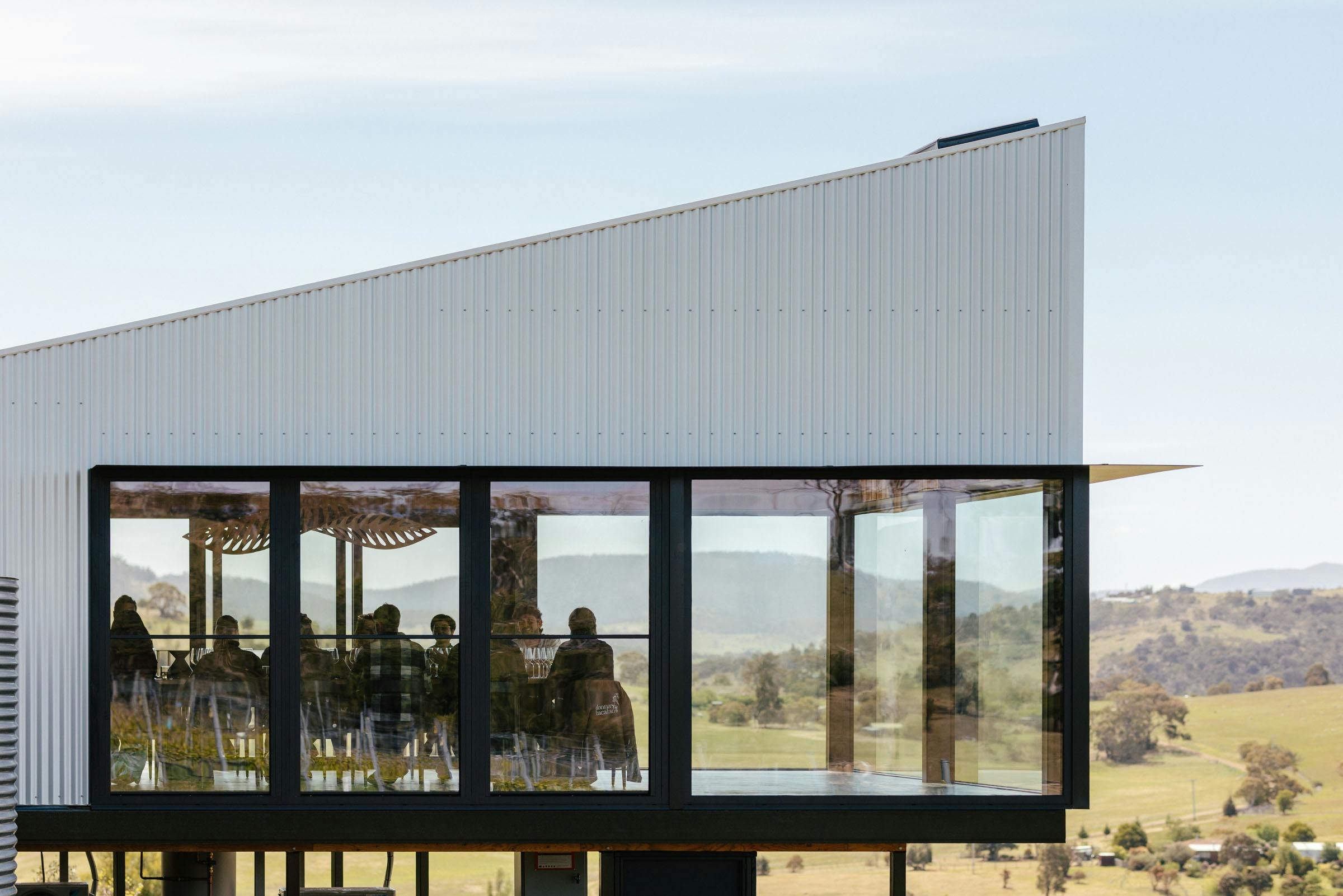 View of the tasting room showing cantilever and people around the table