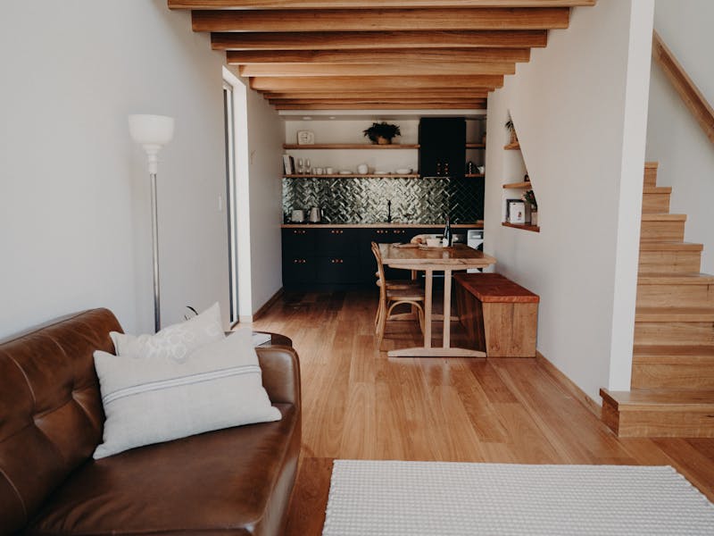 Open plan living area showing stairs access to bedroom.