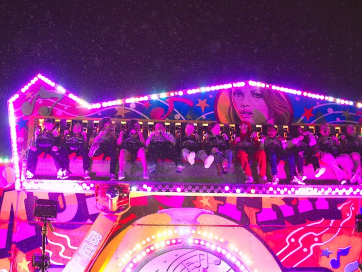 An amusement ride with colorful stage moving in a circular motion