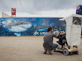 Andrew Bourke chatting to Tumby local Tom in front of his finishe Great White Mural