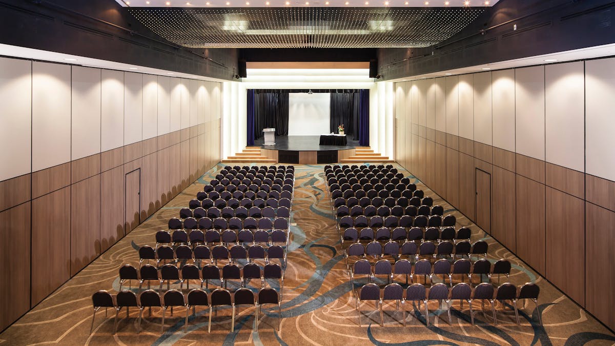 A function room with chairs arranged in rows, prepared for a seminar