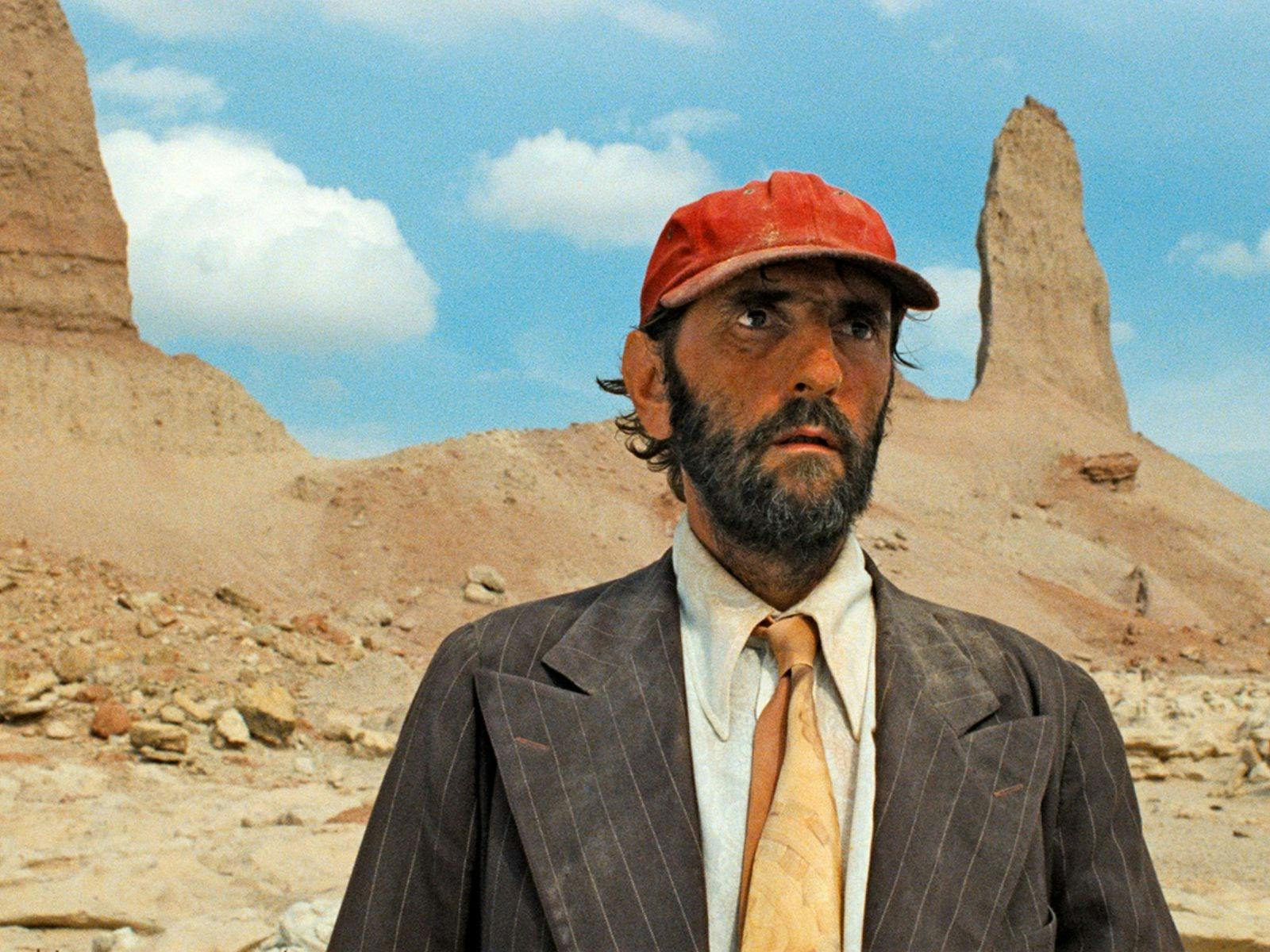 Man in red hat in desert landscape