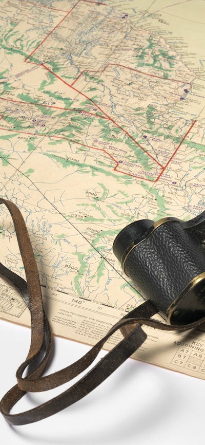 Binoculars and map