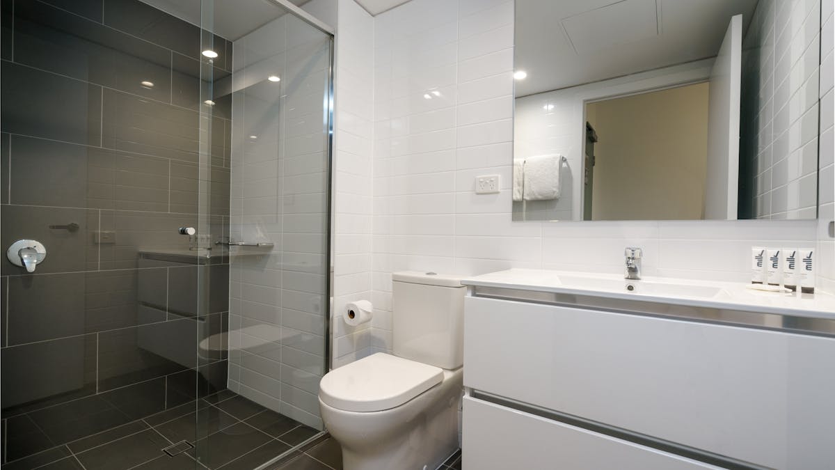 This modern bathroom comes with large walk-in shower and premium MILK amenities.