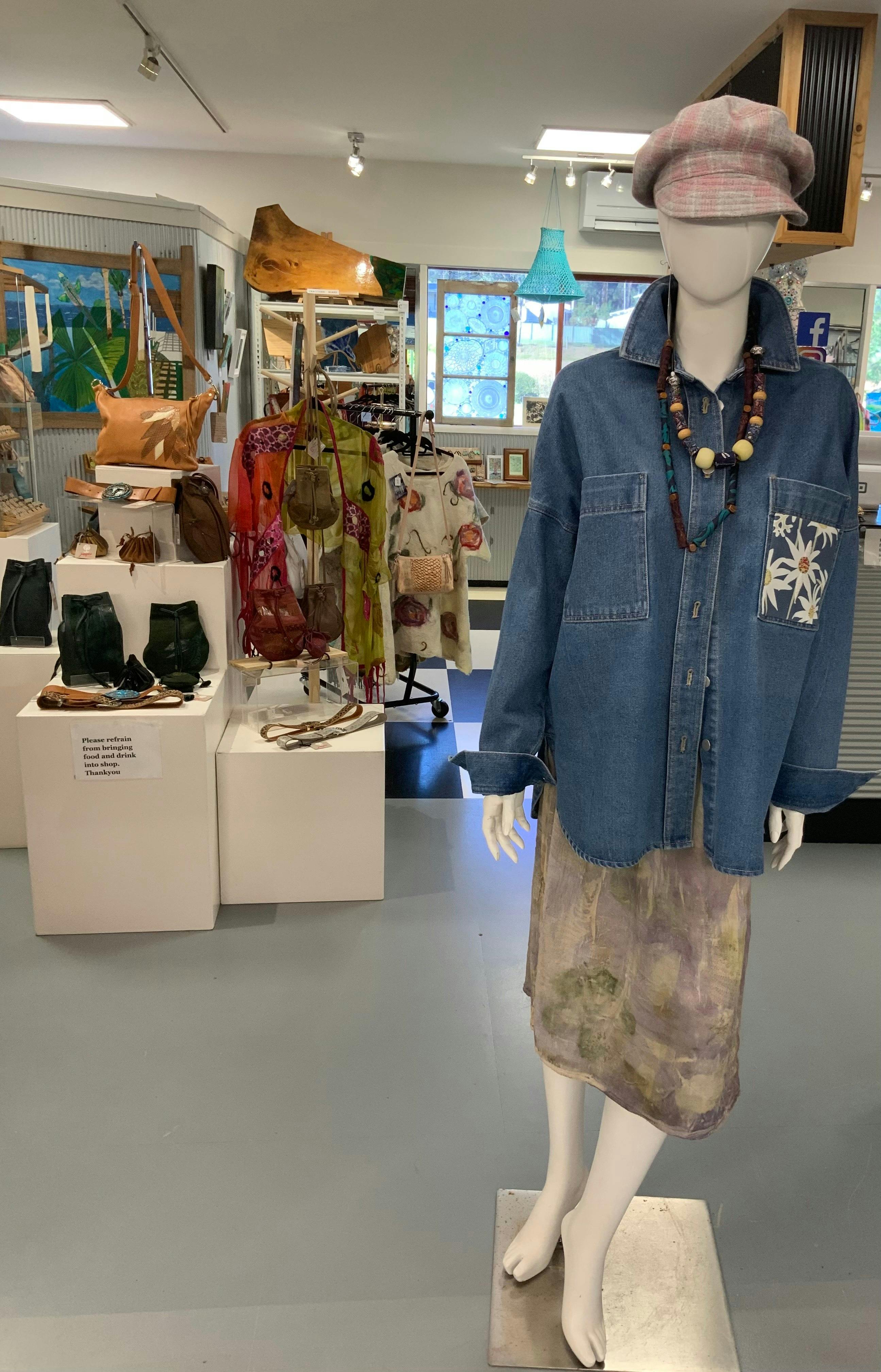 Photo of inside the gallery, showing leather handbags and Denim shirts