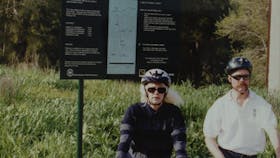 2 cyclists pausing on the Trail