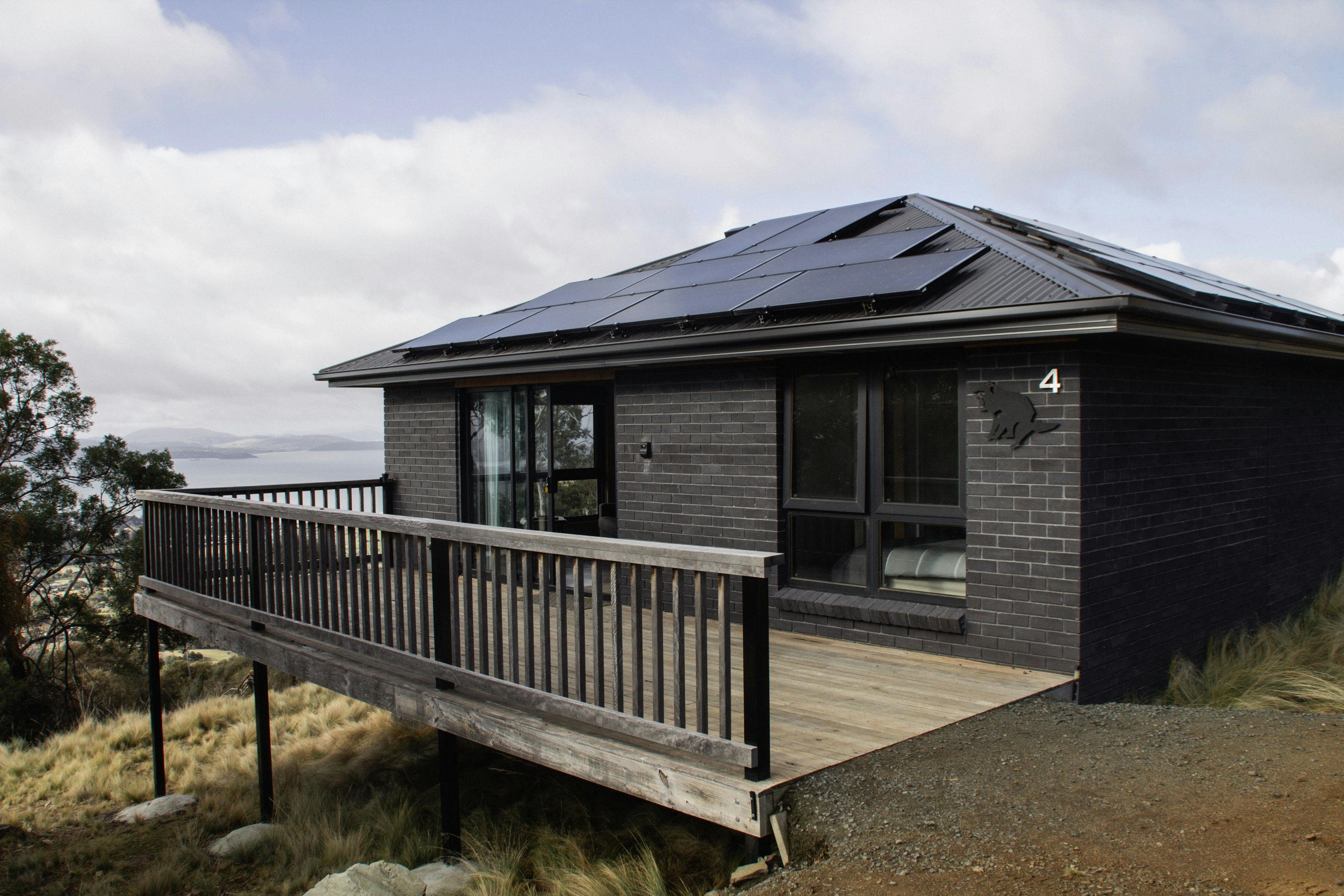Exterior of Devil House showing the accommodation, deck and surrounding natural bushland