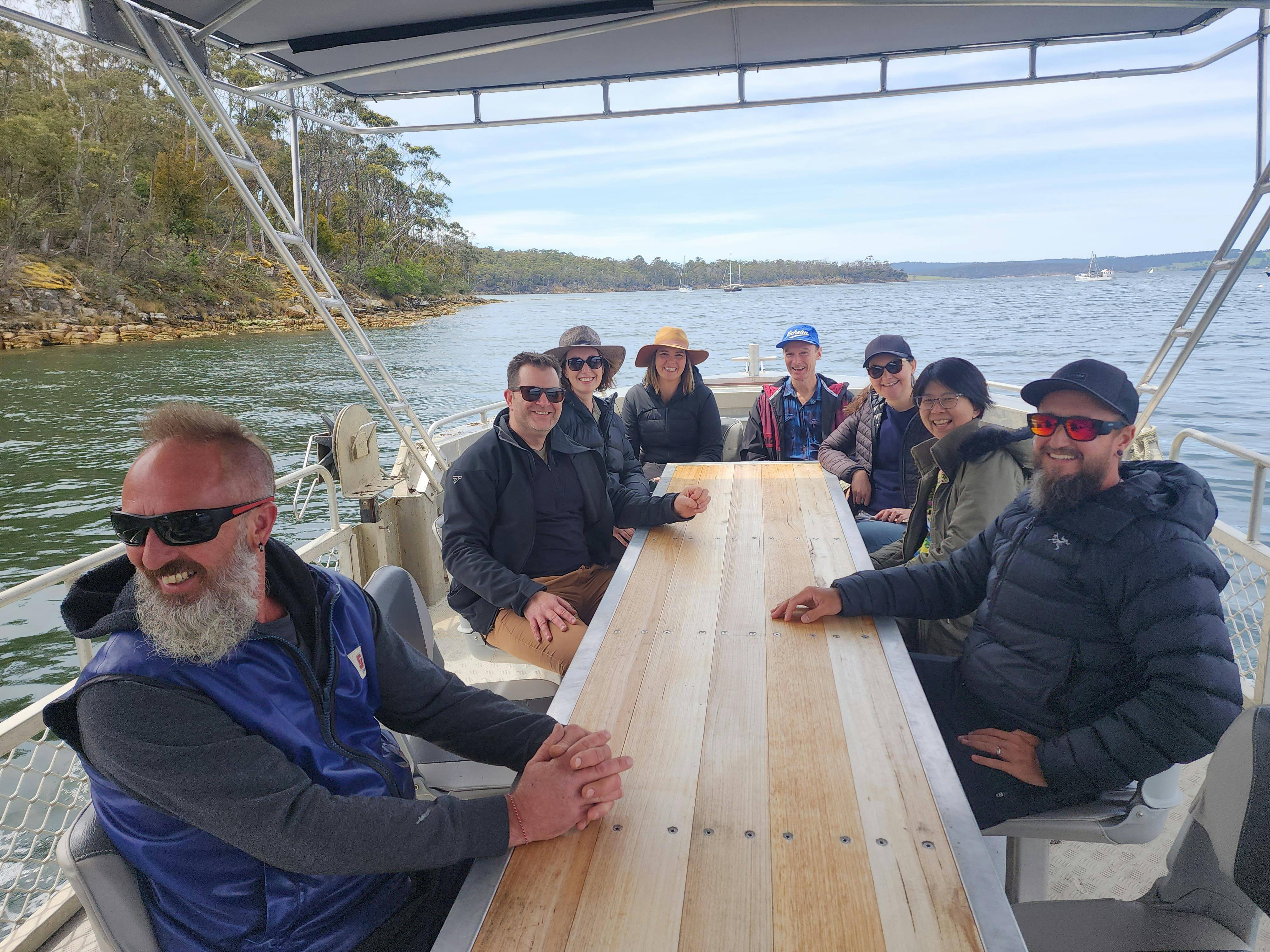 Group seated together smiling on the boat