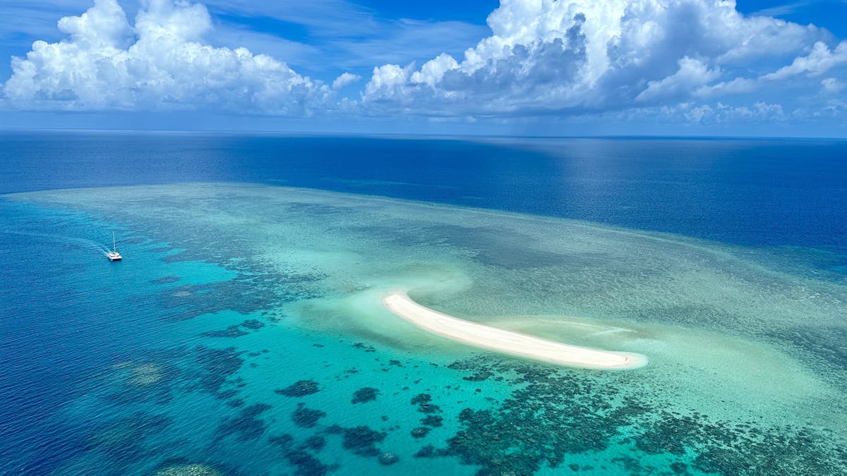Bird view over the coral sea and Mackay Cay  on the Outer Barrier Reef off Cape Tribulation