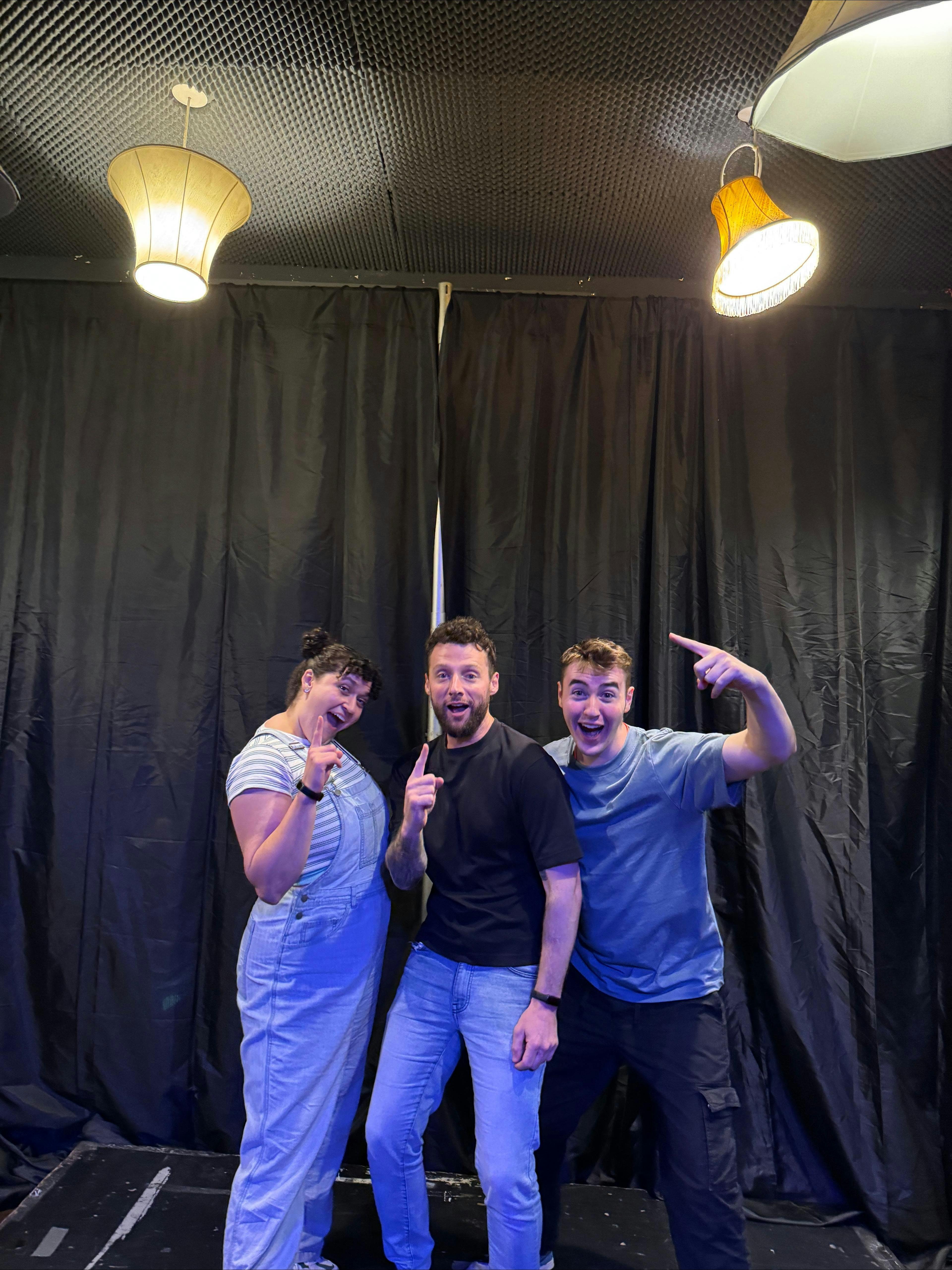 3 performers on stage smiling