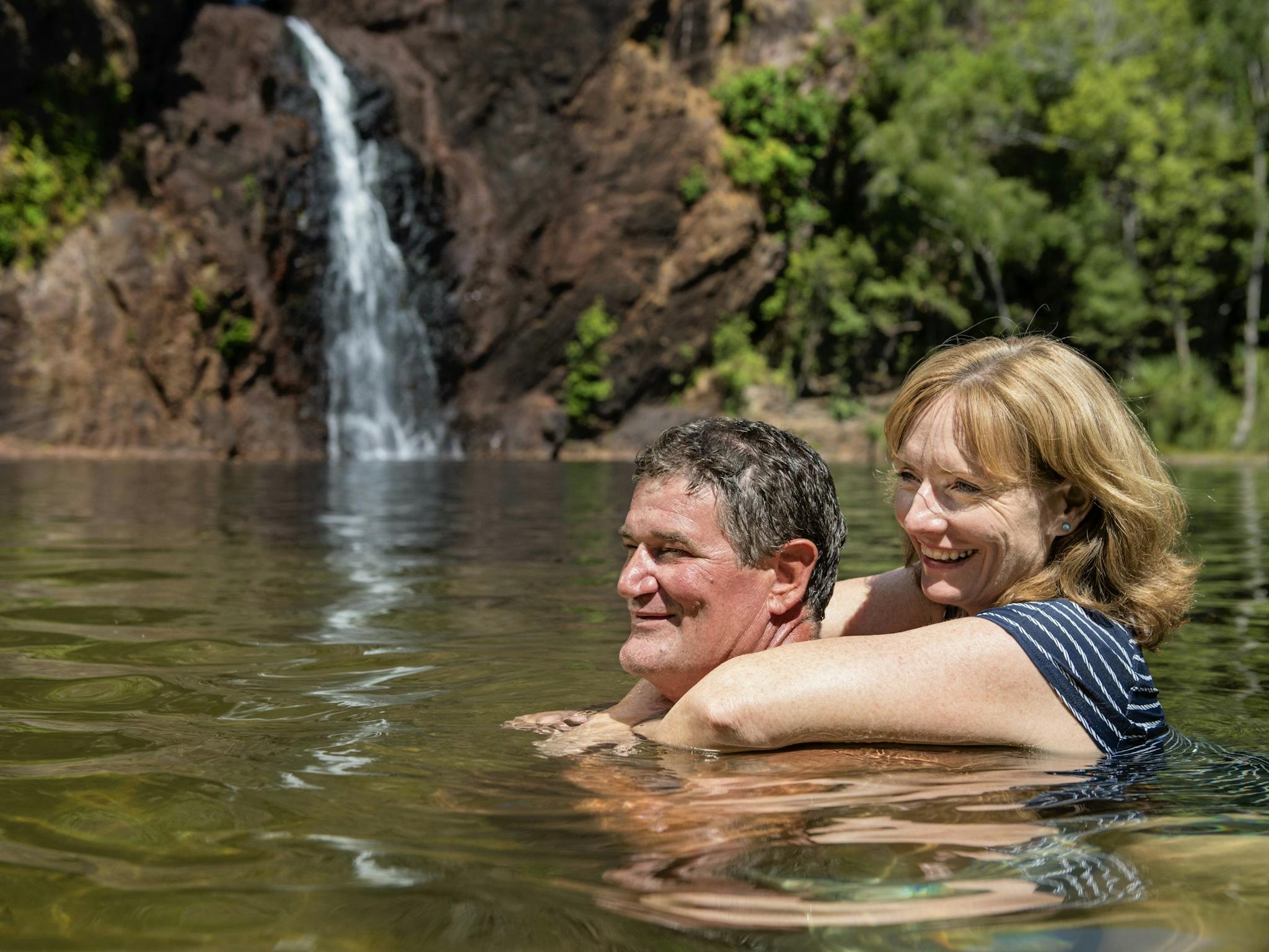 Visitors swimming in the waterhole at Wangi Falls.
