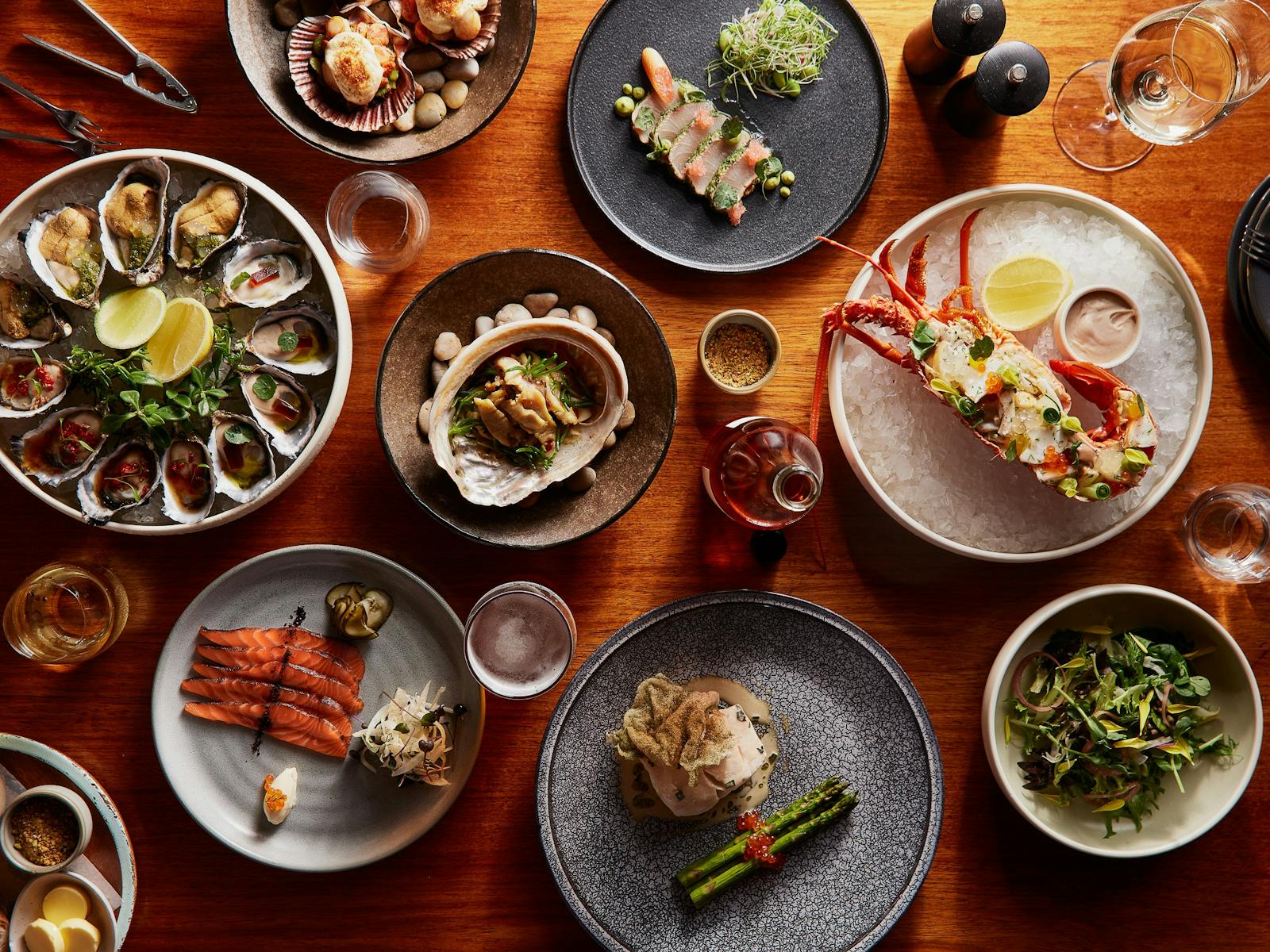 A selection of seafood dishes including salmon, lobster, abalone, oysters and blue eye trevalla
