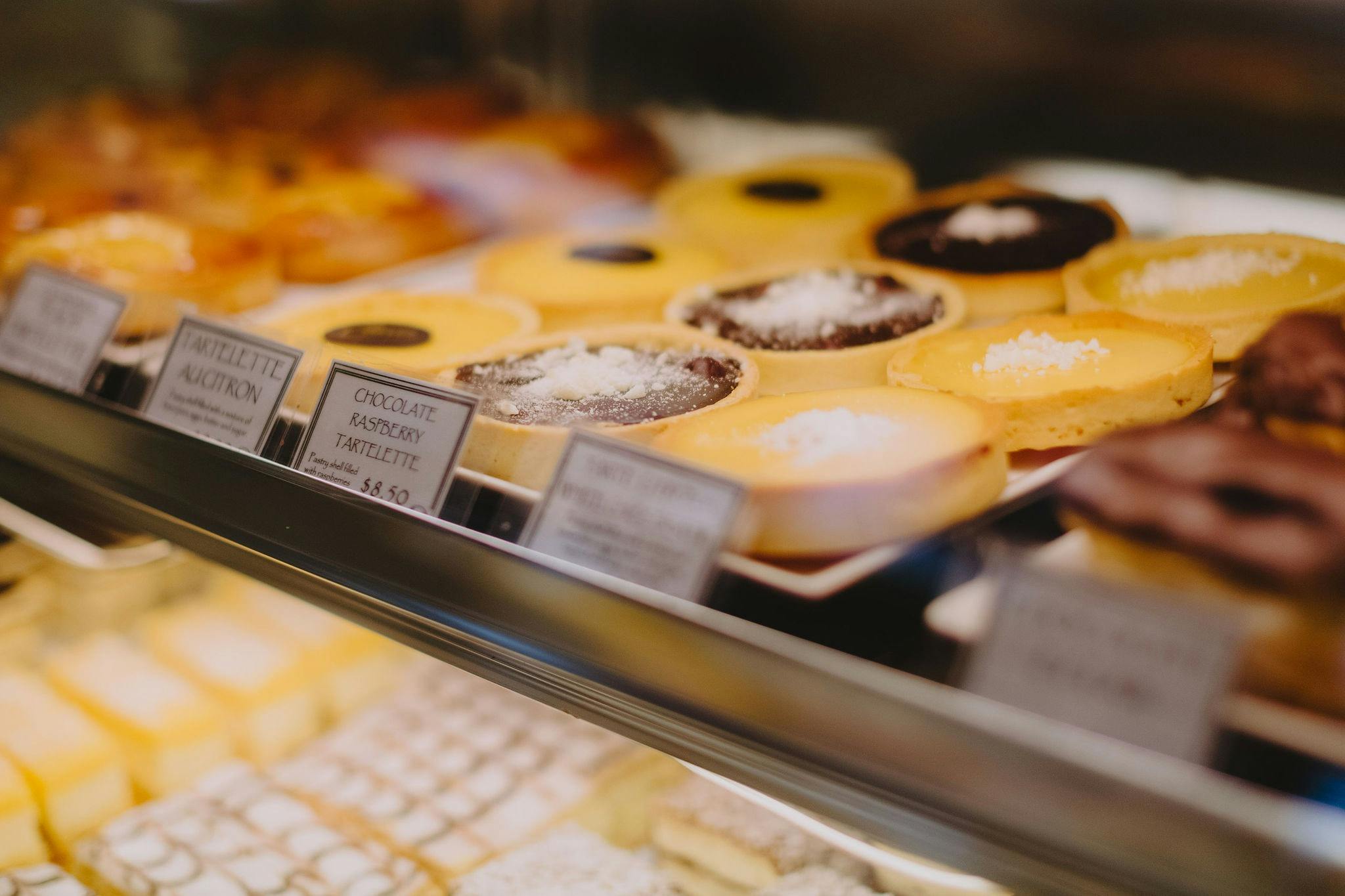 Display window showcasing various sweet treats at Wagga Wagga's Artisan Baker.