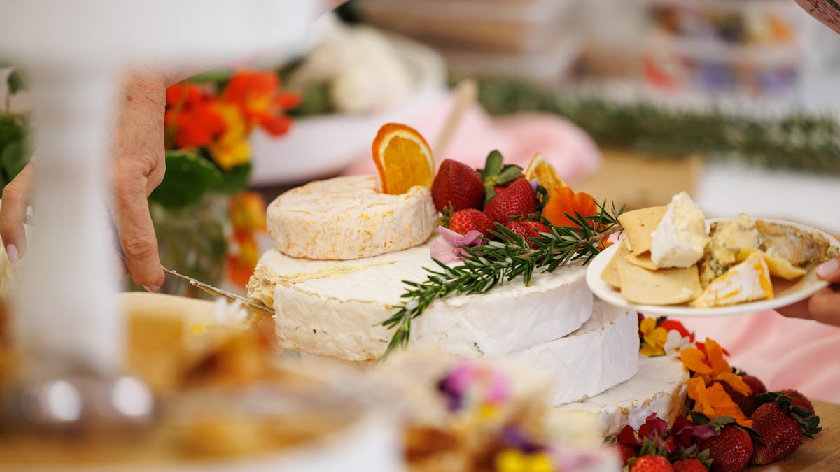 Close up of a charcuterie board with cheese and fruits