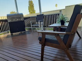 4 burner bbq, spacious deck, jack and jill seating, extra seating as well in a garden setting.