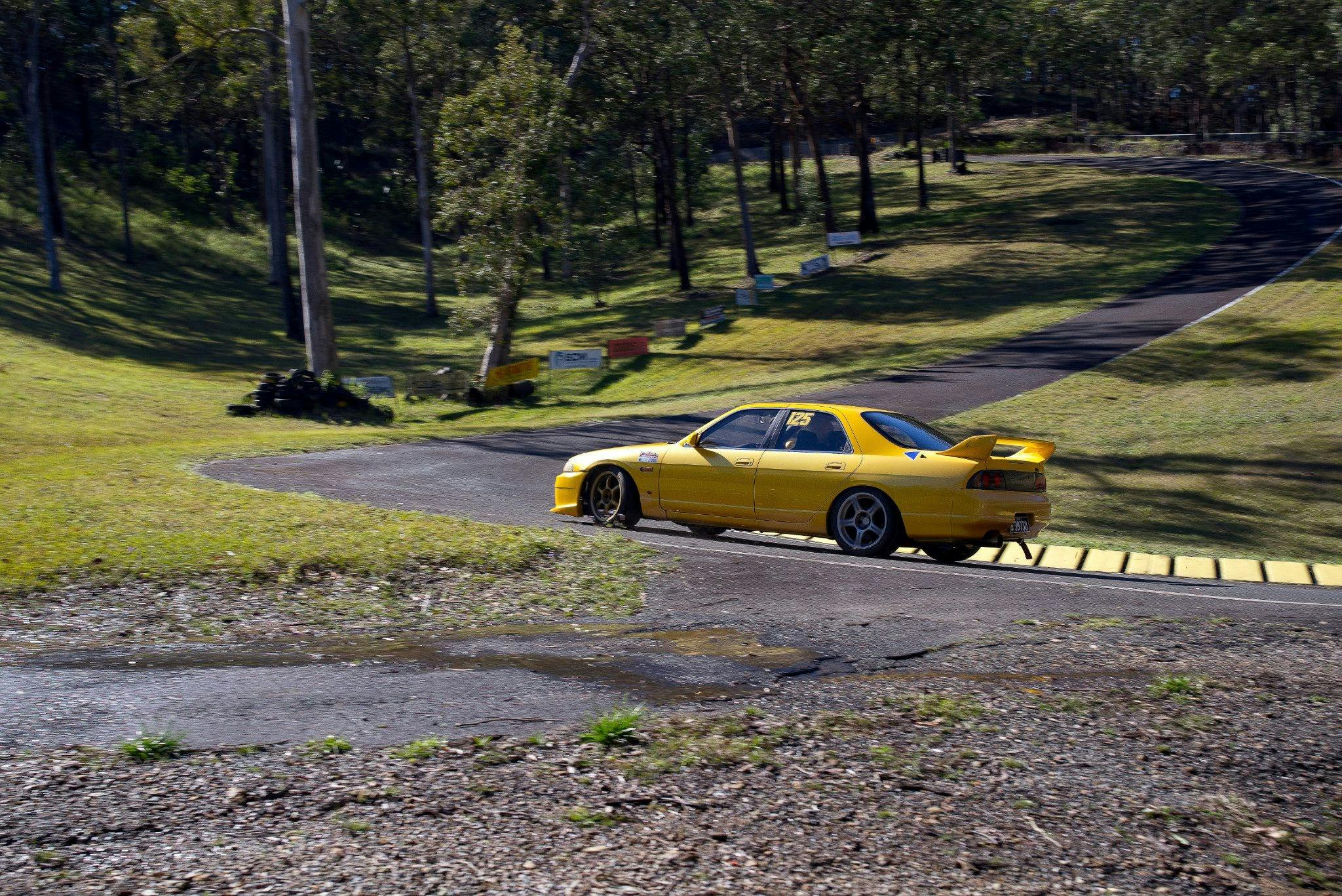A competitor exiting the first corner to accelerate up a 1 in 3 grade climb in a Nissan Skyline