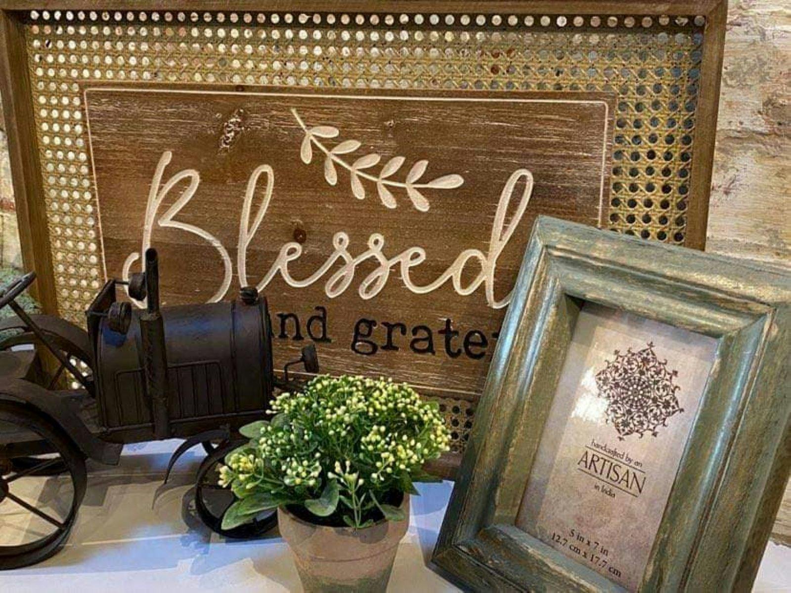 Home decor that includes 'Blessed' brown picture frame, black car and a small picture frame.