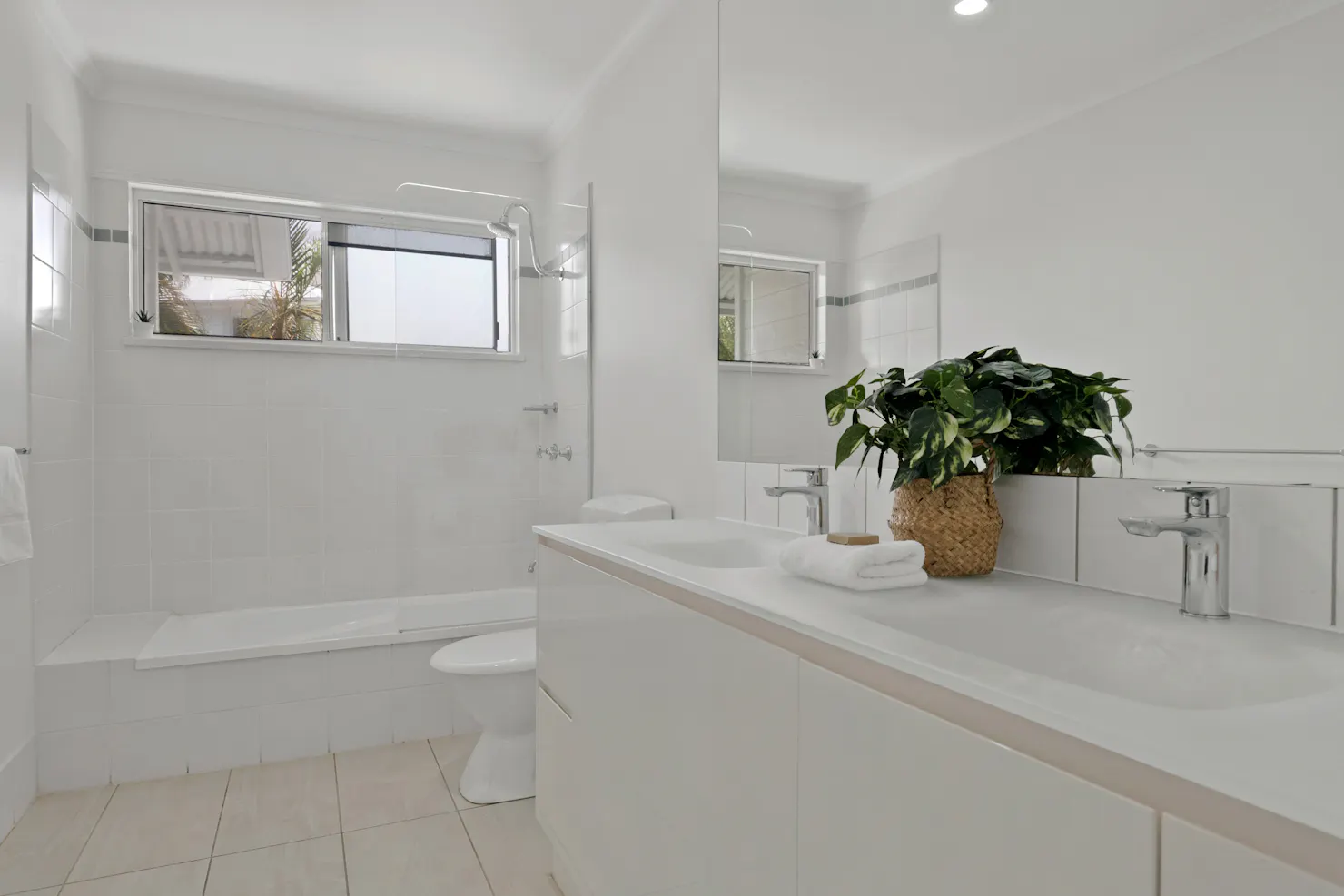 Bathroom with vanity, toilet and shower over bath