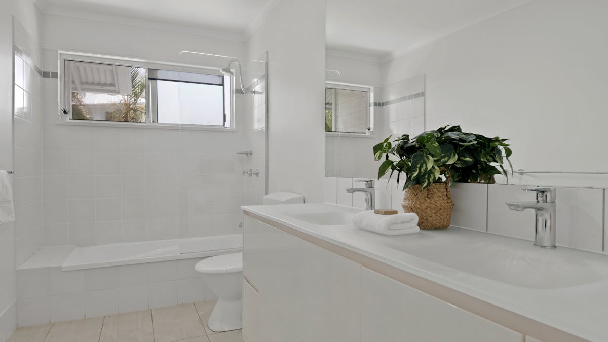 Bathroom with vanity, toilet and shower over bath