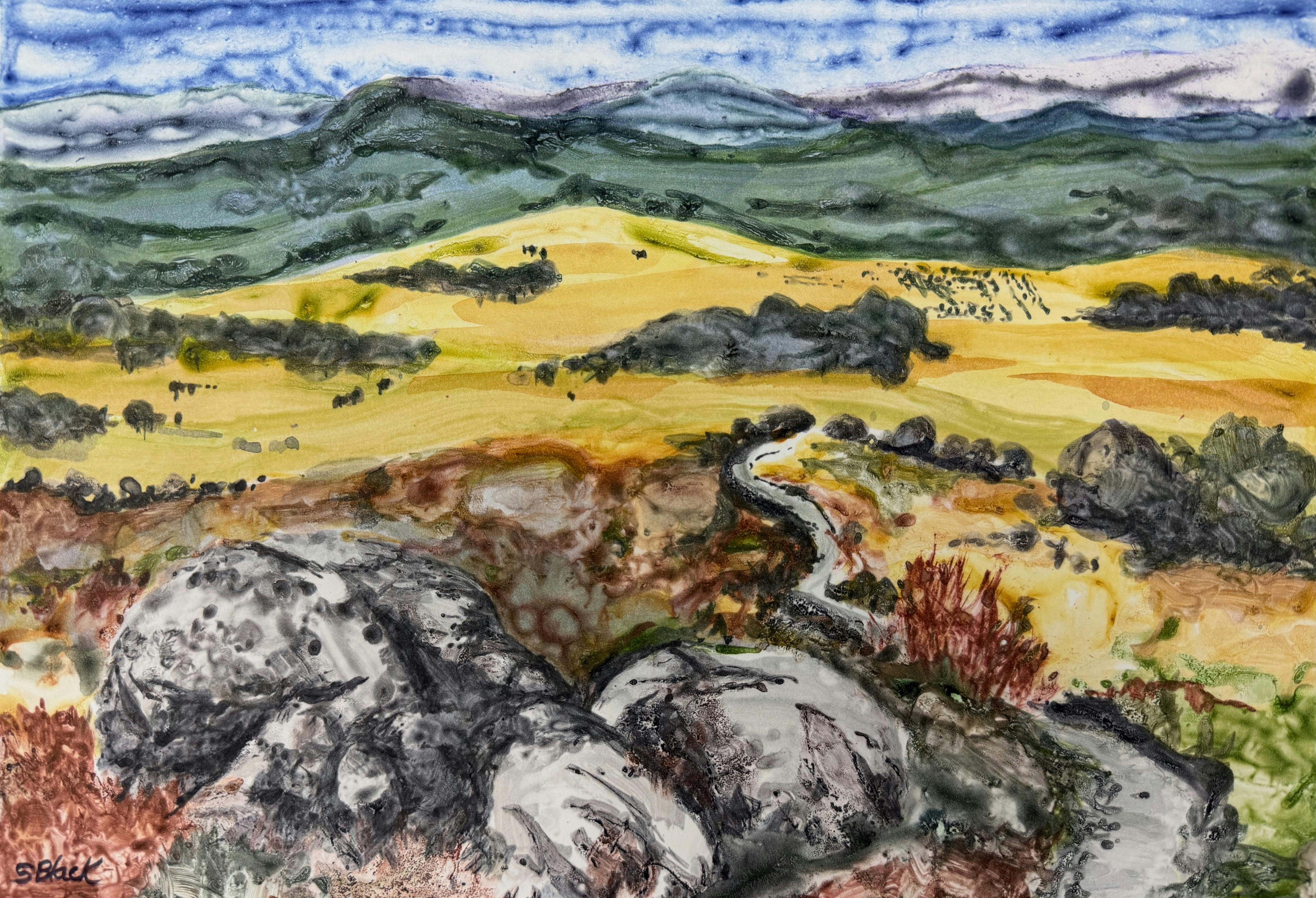monoprint of a landscape with mountains and boulders with a blue sky