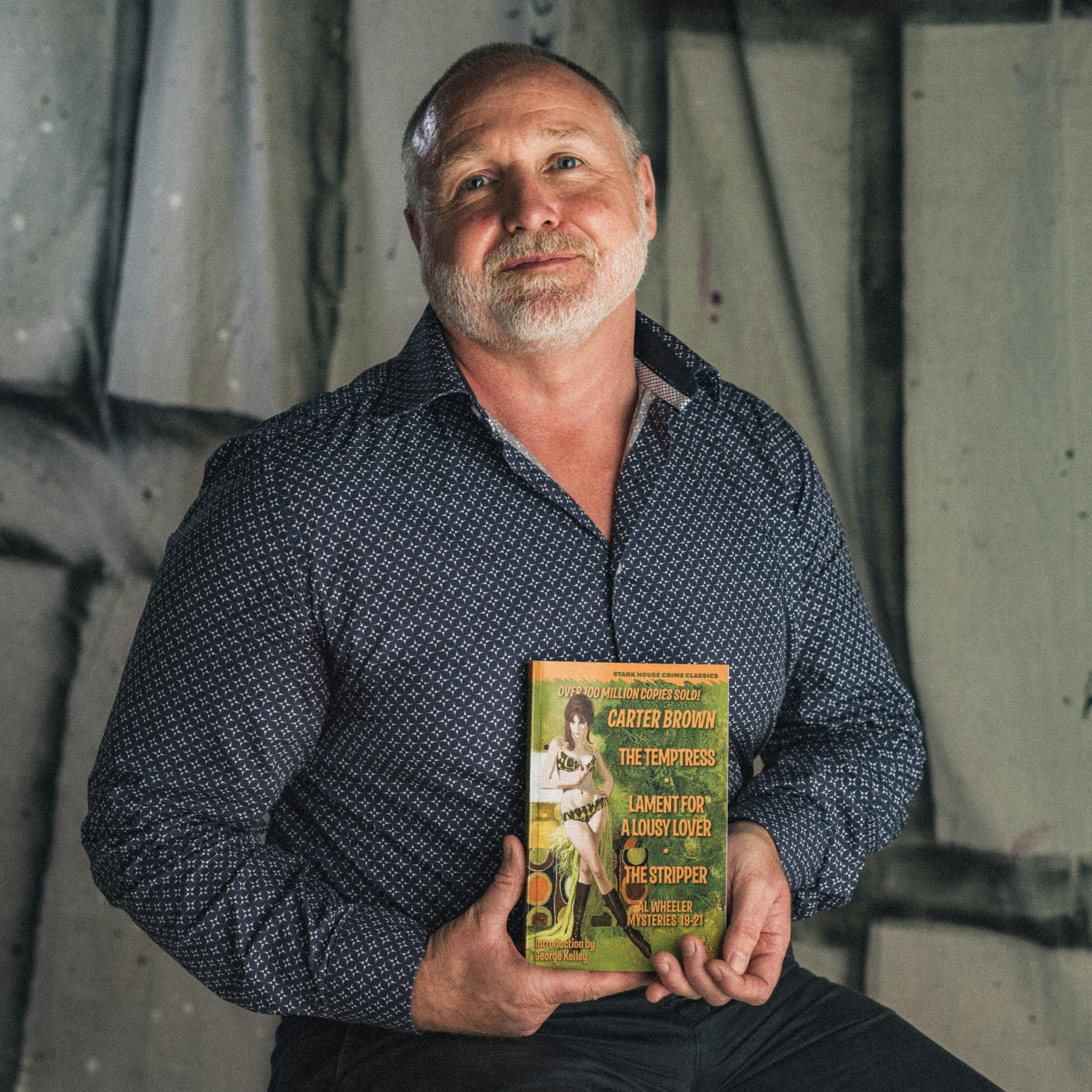 A man posing with a book