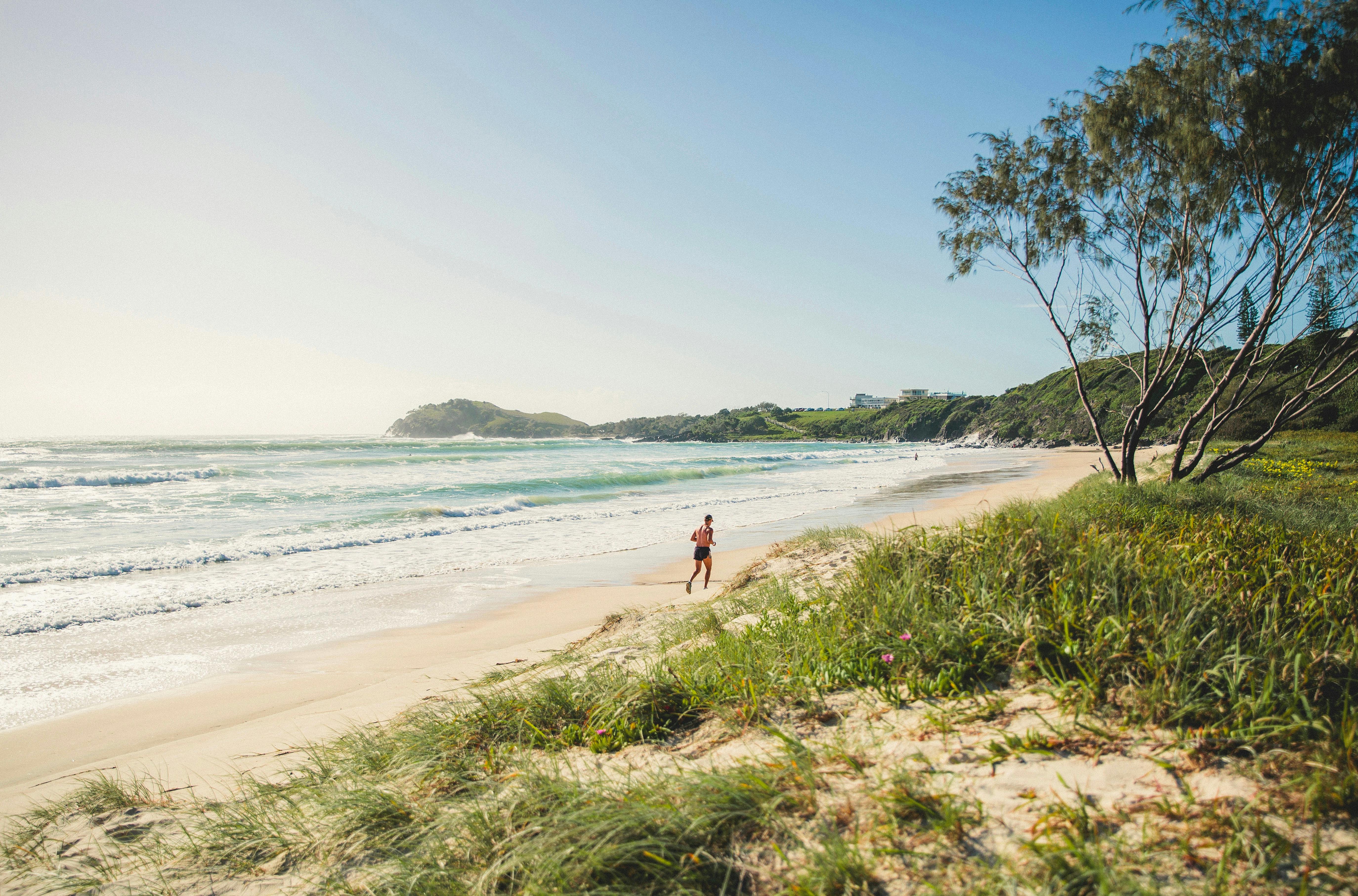 A man running along the beach.