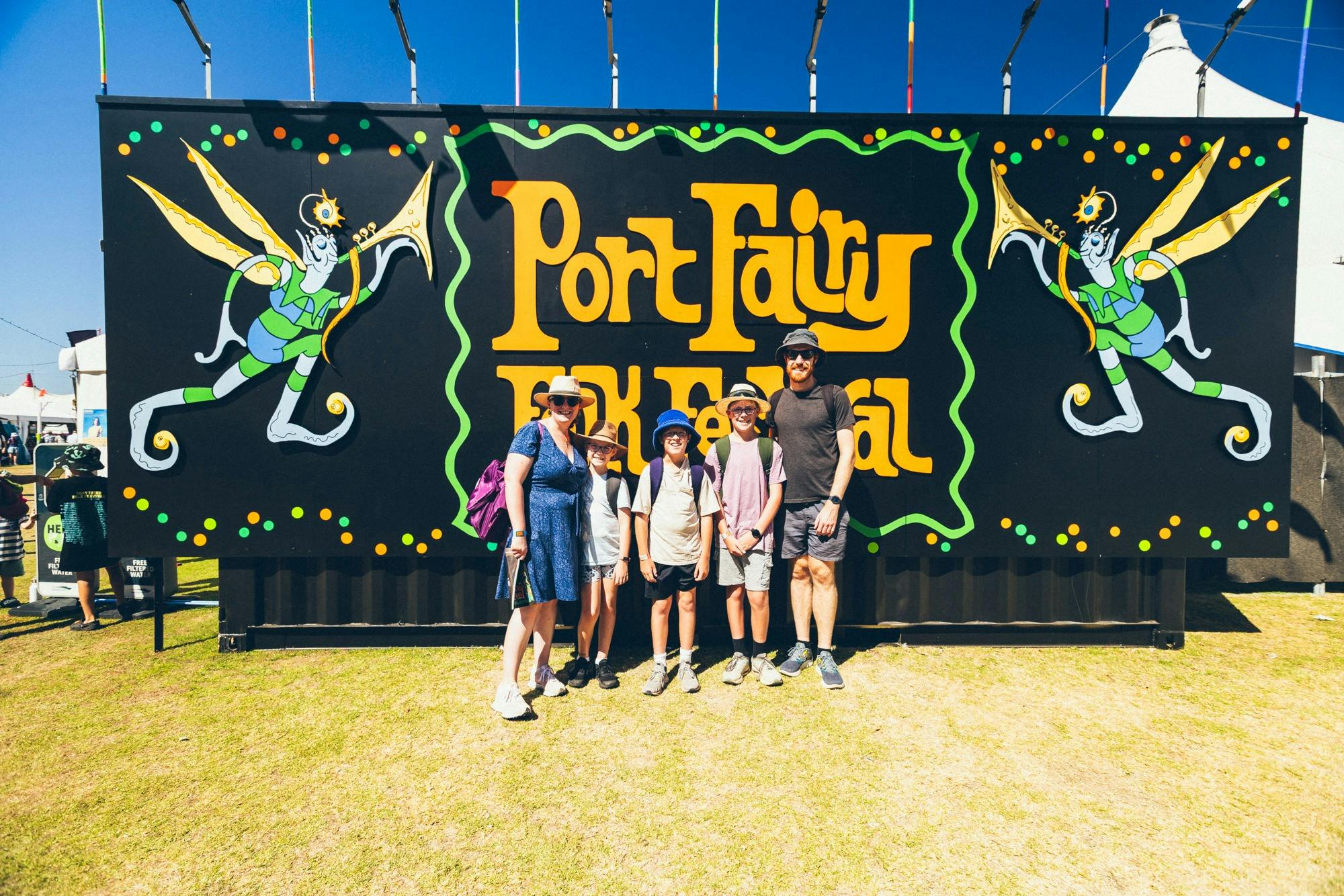 Family standing in front of our photo wall getting their photo taken at the enrty of the arena.