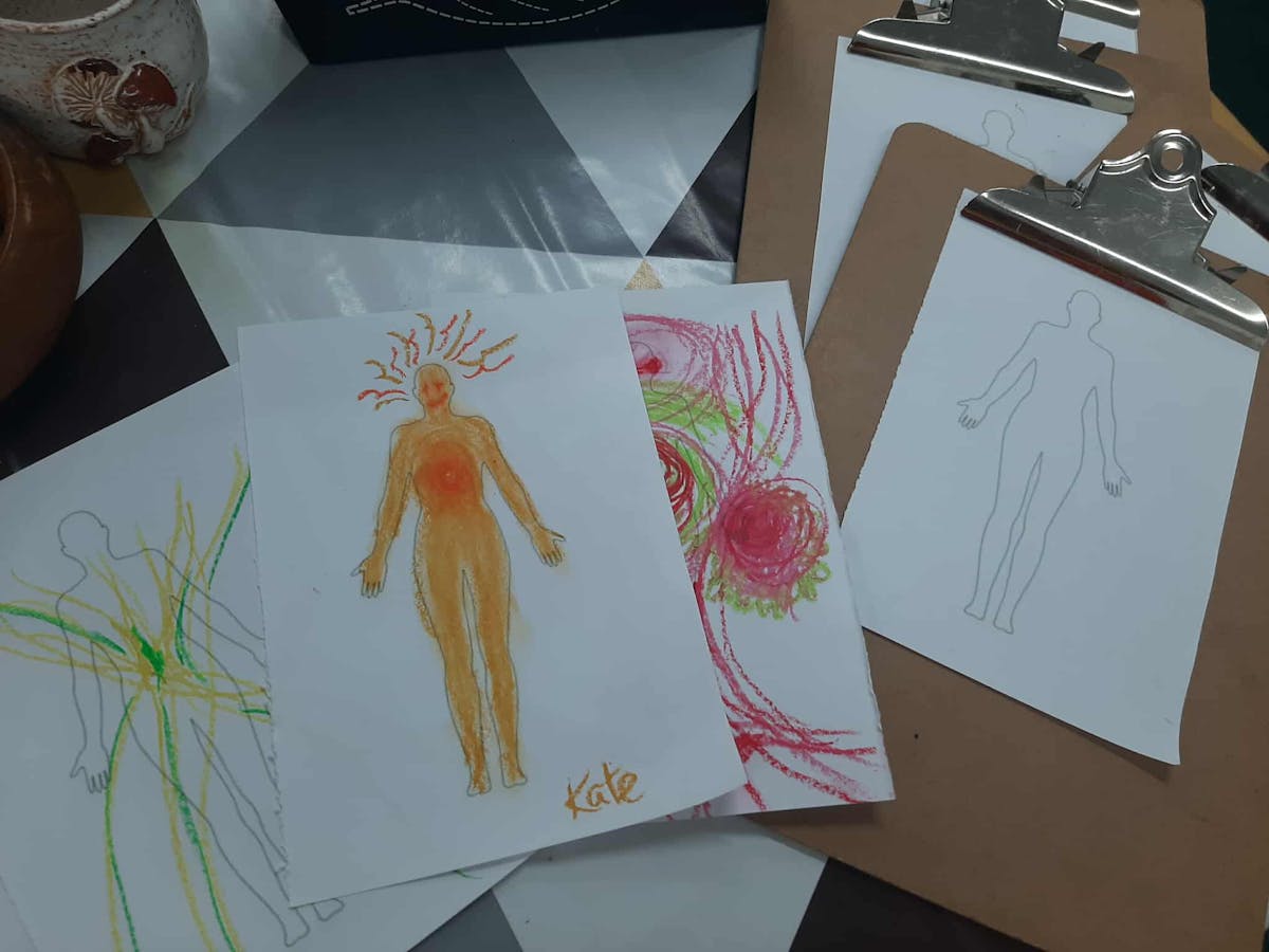 Outlines of human figures with crayon drawing over the top Outlines of human figures with crayon drawing over the top