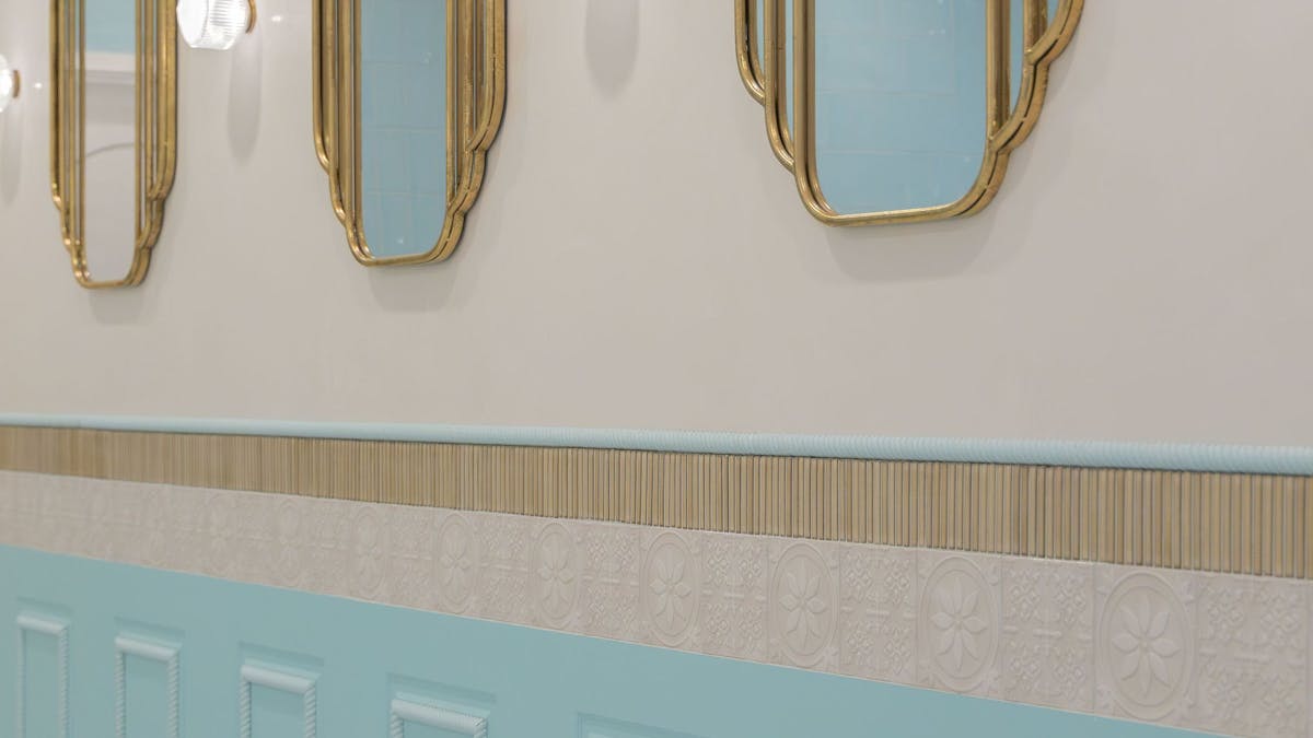 Blue wall panelling and decorative tile detail inside LUMA Gelato