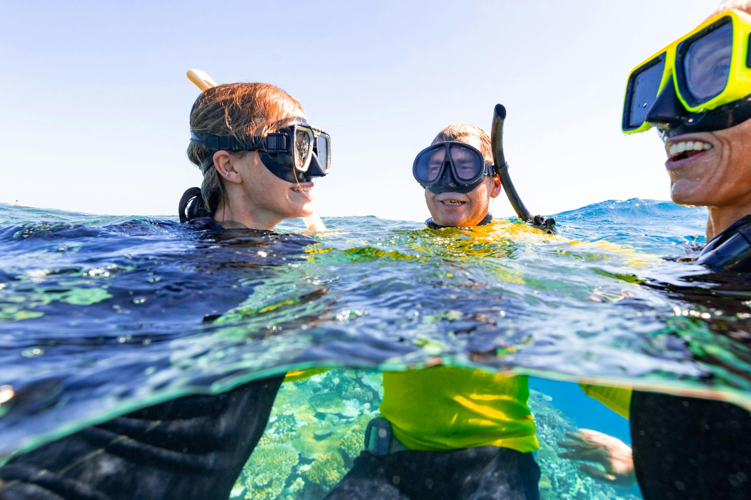 2 Snorkellers in the water with Master Reef Guide