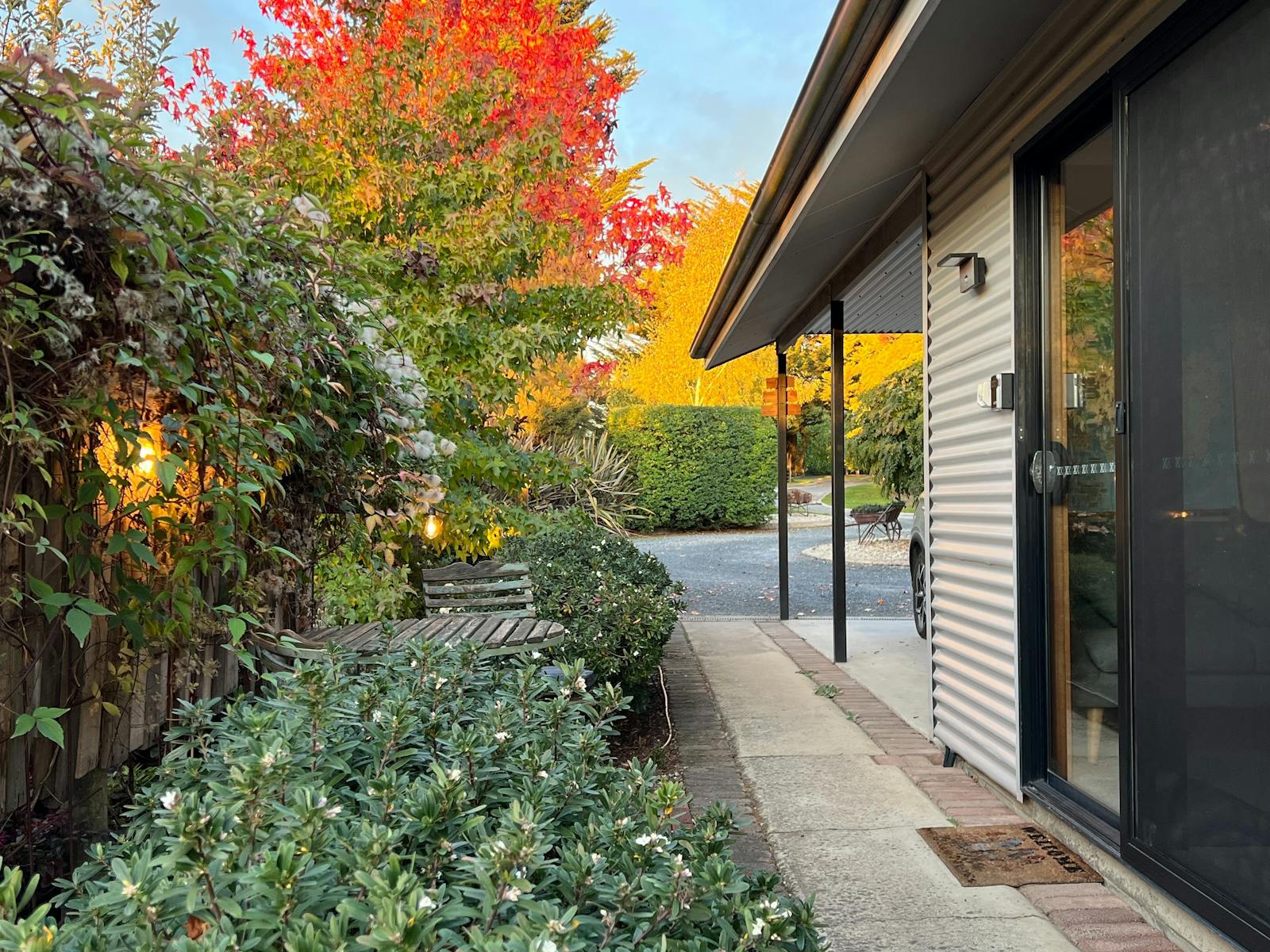 Front door, carport parking, garden surrounds
