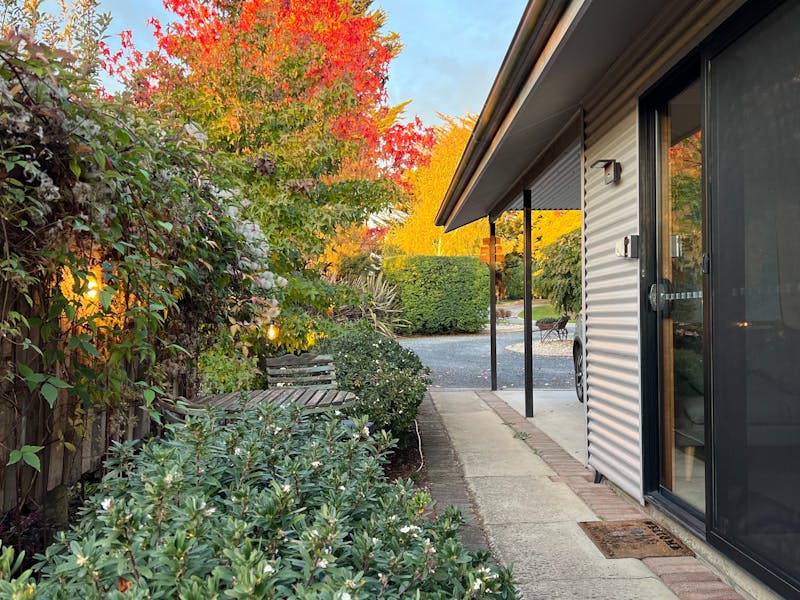 Front door, carport parking, garden surrounds