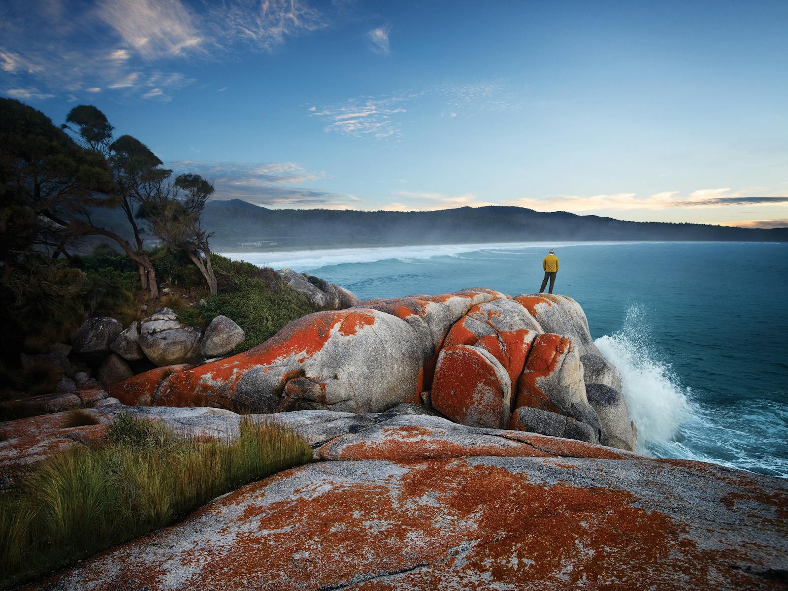 Man on Granite Rocks Orange Lichen Park Trek Walking Holidays Bay of Fires Hiking Tour