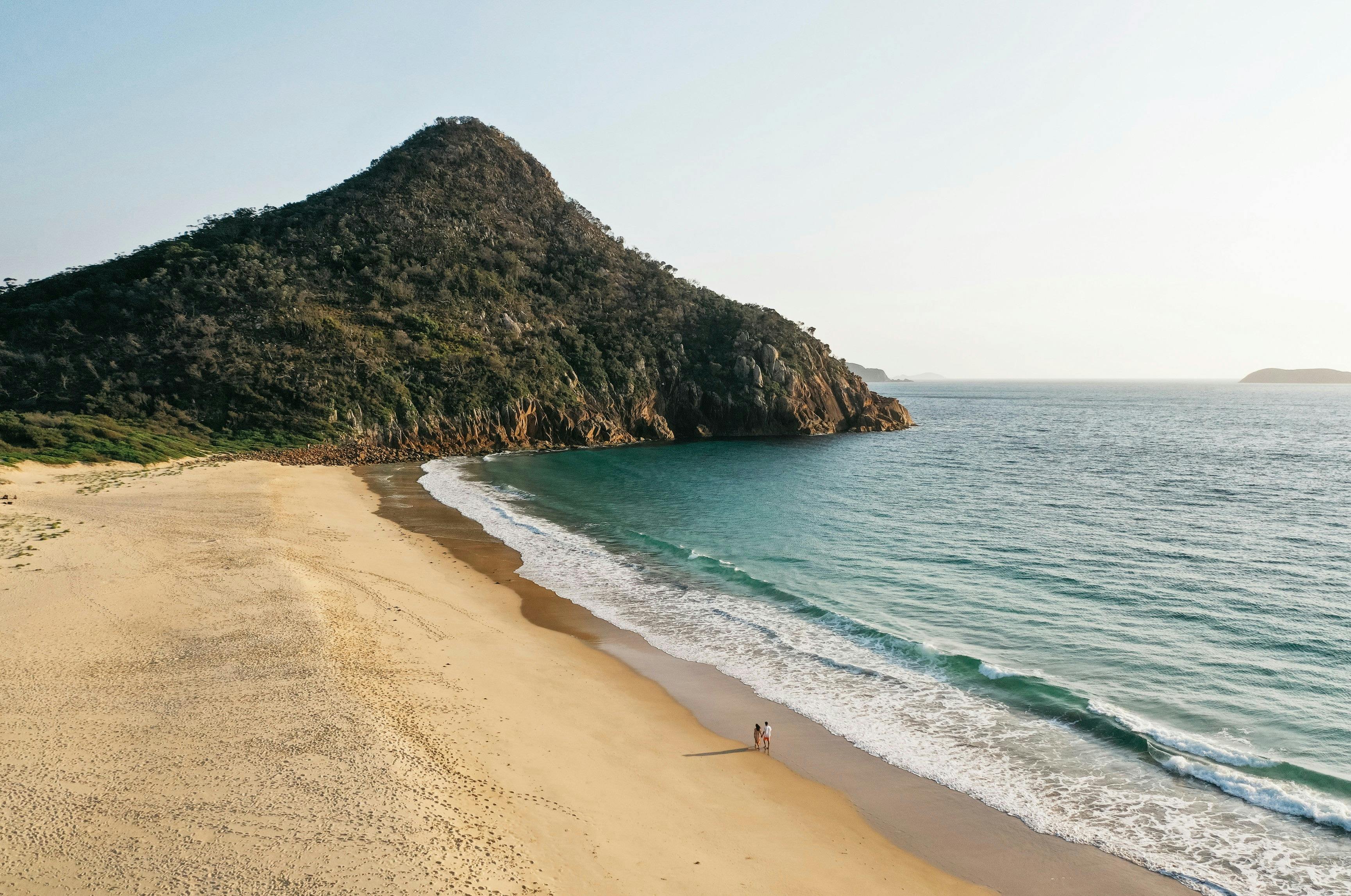 Couple enjoying a walk along Zenith Beach, Port Stephens
