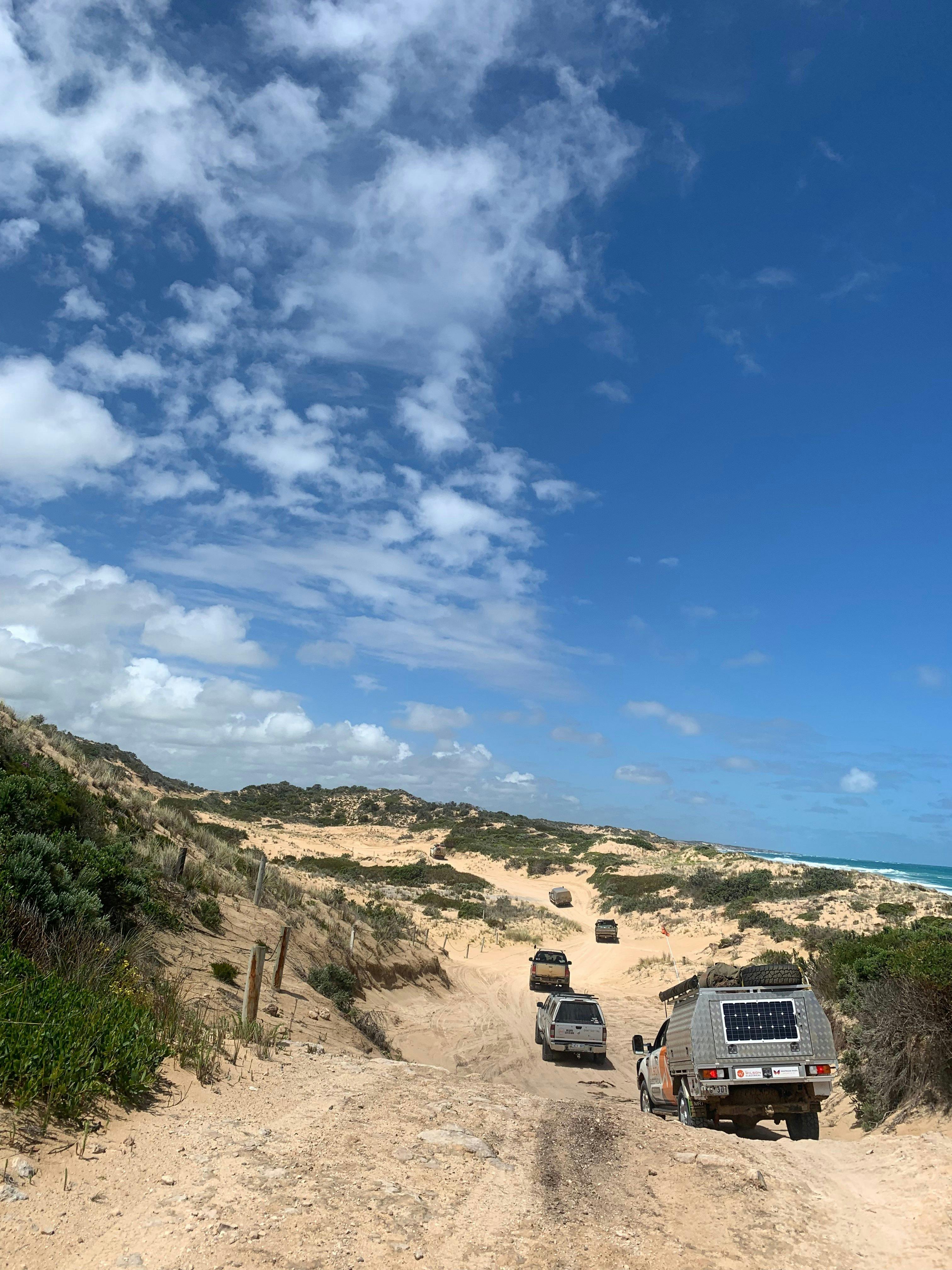 Tour vehicles travelling along the track from Robe to Beach Port