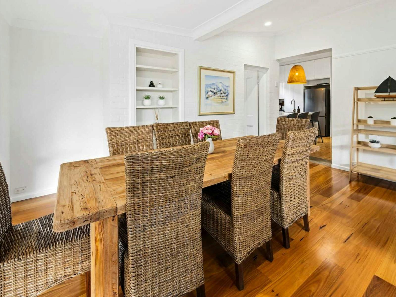 Dining with room with large wooden table and rattan chairs