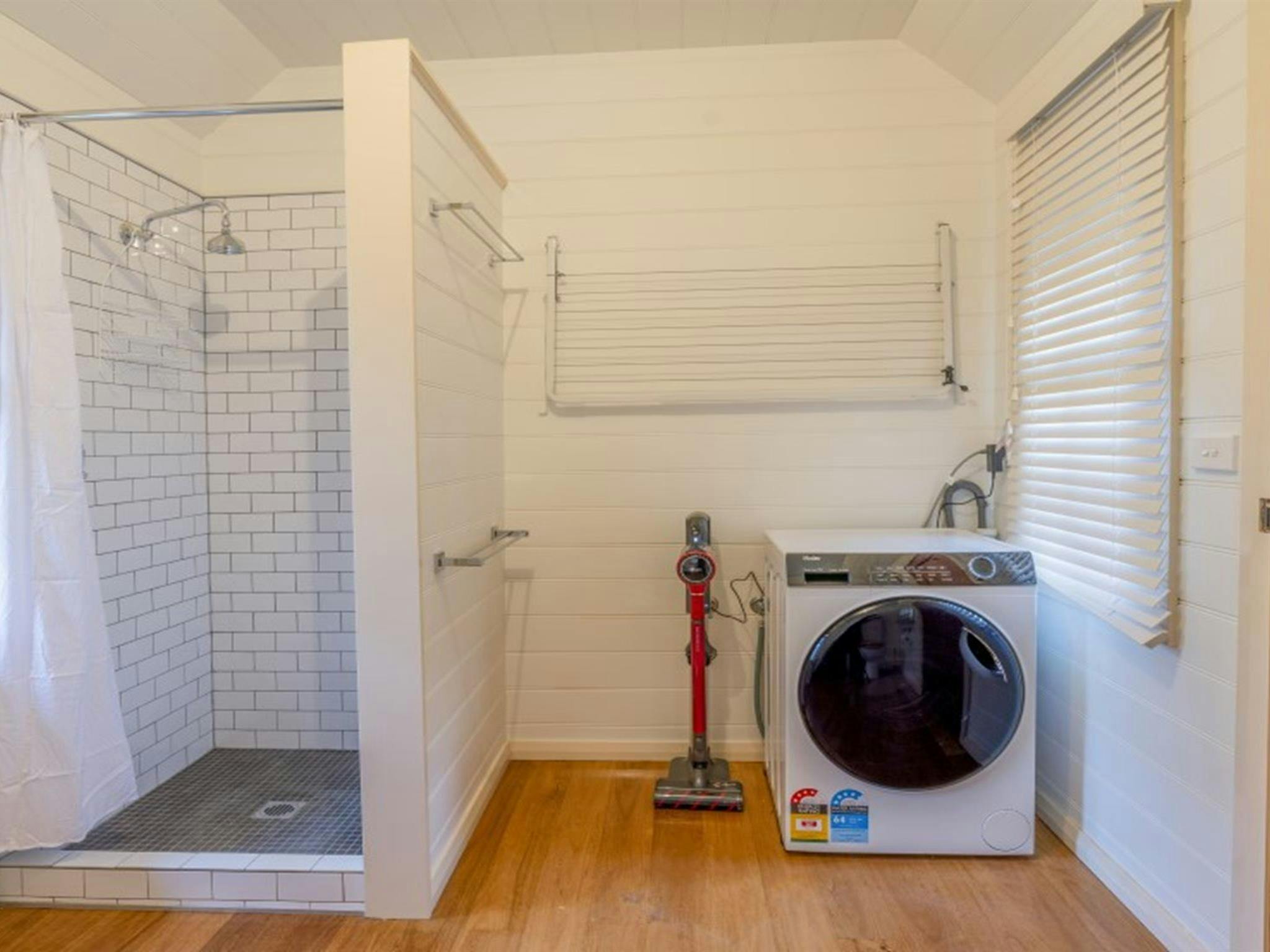 The external bathroom with shower and washing machine in Fairfax House, Hill End Historic Site.