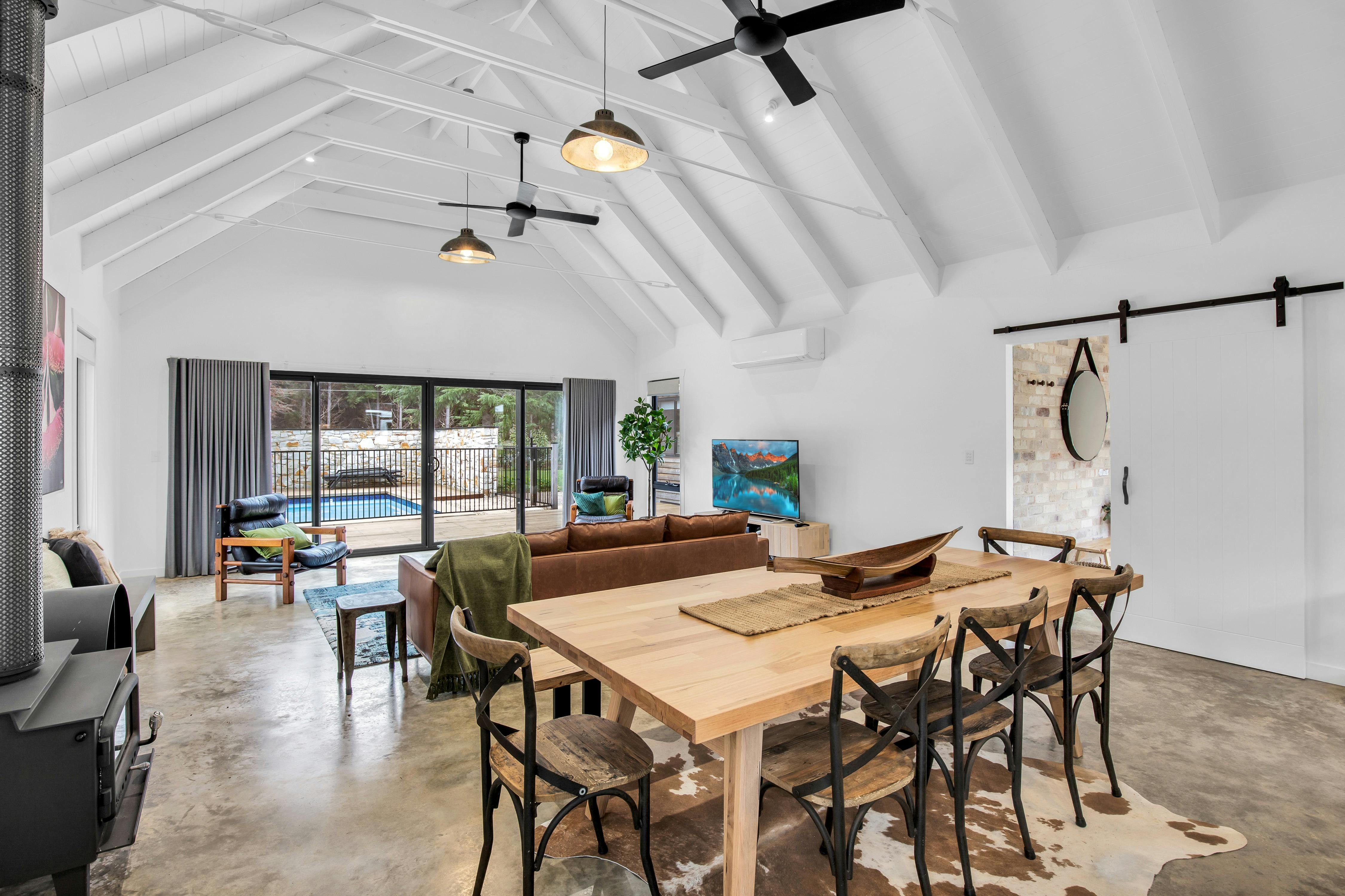 Kitchen table and chairs looking over the loungeroom out to the pool