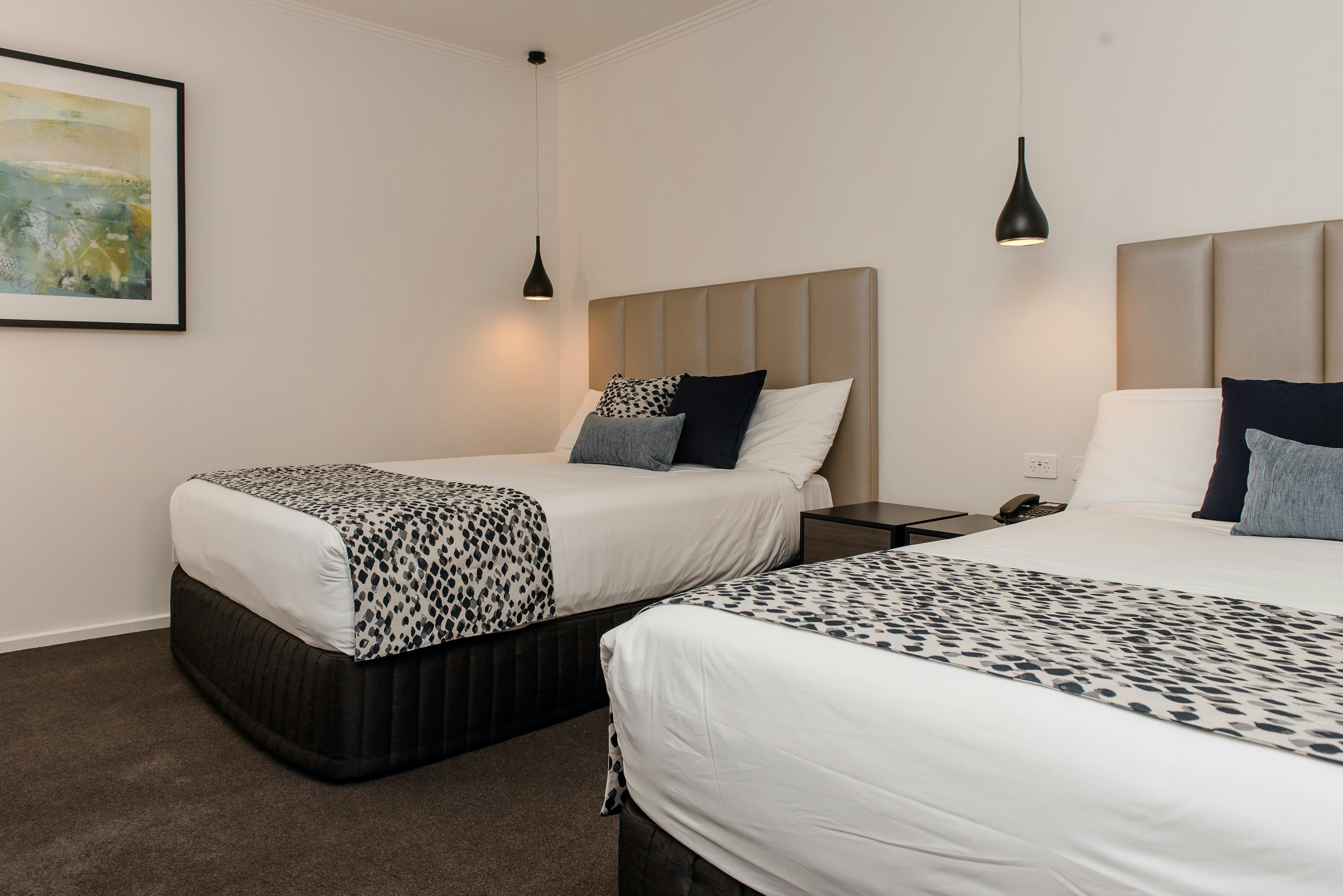 Suite offering two double beds, LCD television, streaming services and corporate desk at The Gateway