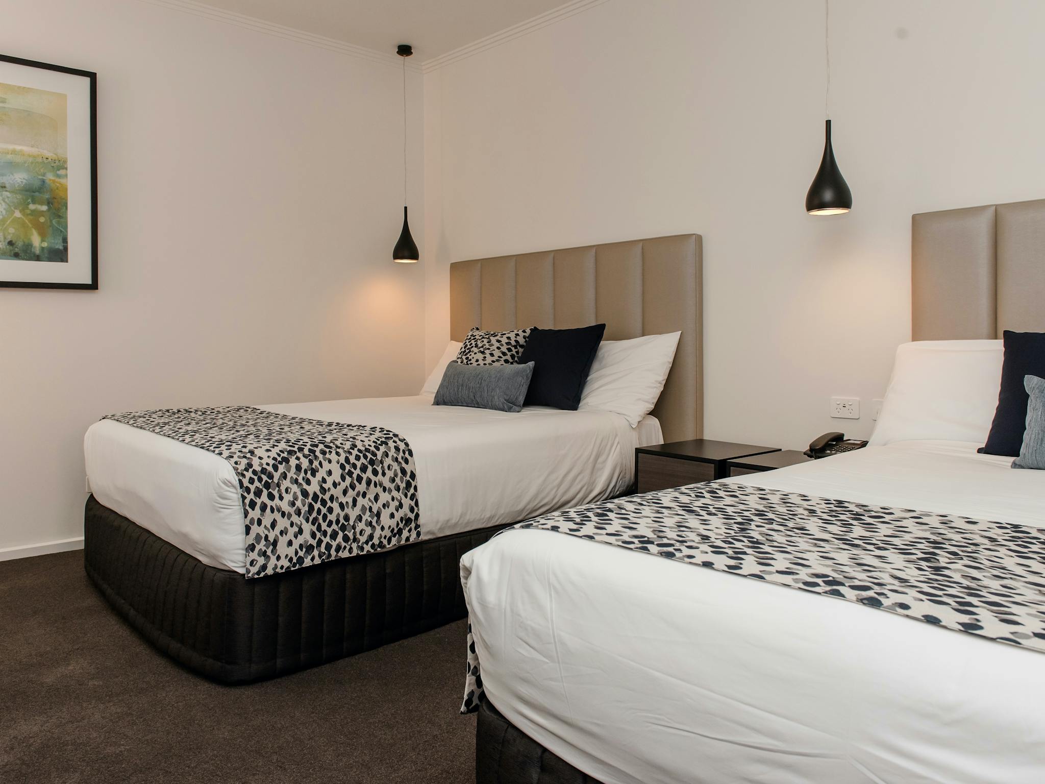 Suite offering two double beds, LCD television, streaming services and corporate desk at The Gateway