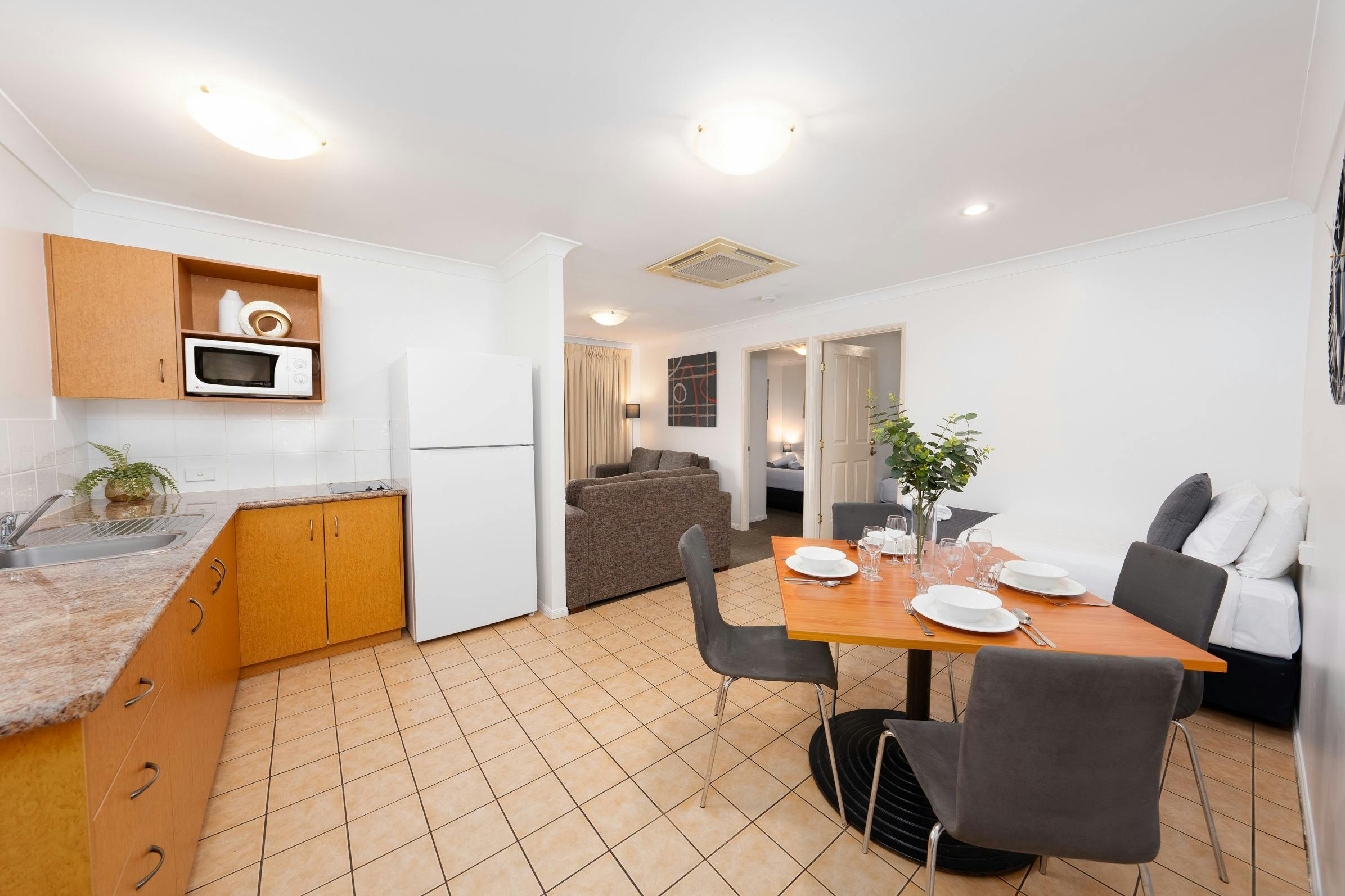 2 Bedroom Apartment open plan living with dining setting, kitchenette and lounge area
